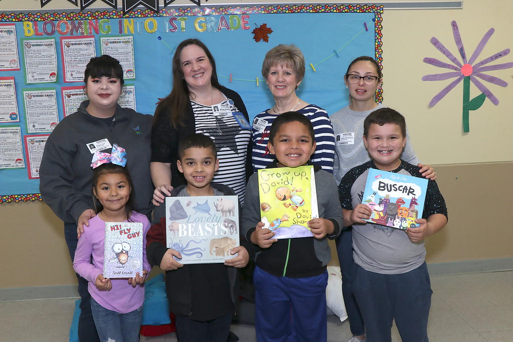 lee college staff stand with students holding books