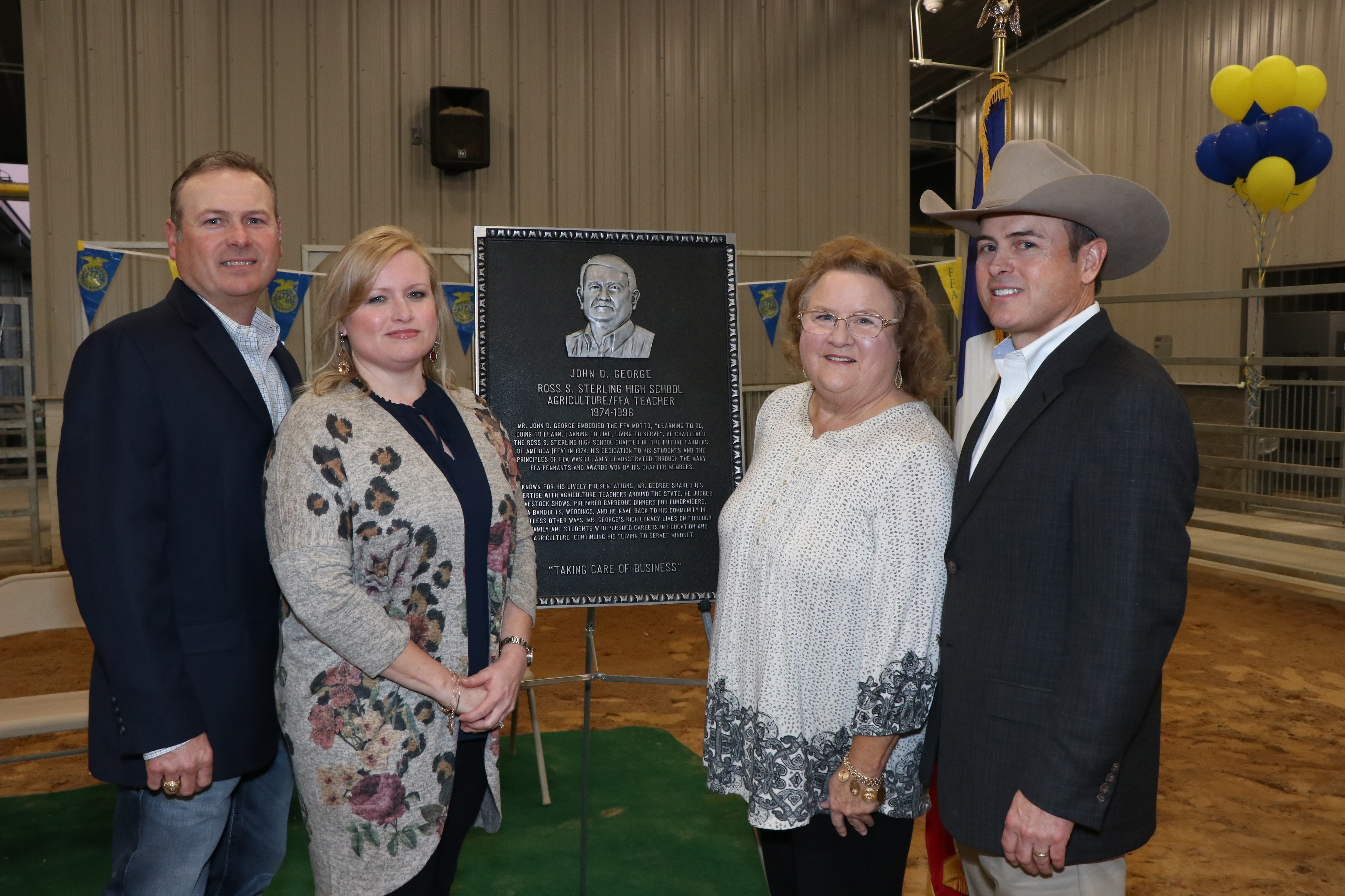 The George family stand by the plaque