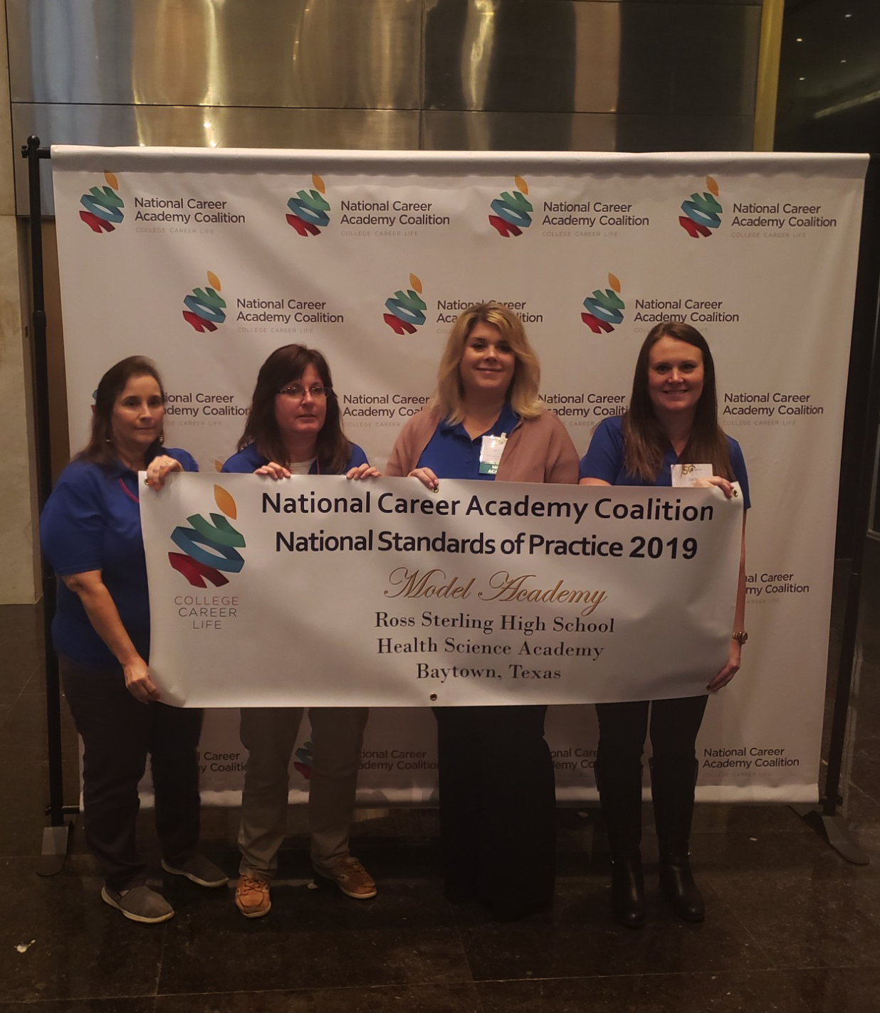 RSS Staff display the banner proclaiming the RSS STEM Academy a Model Academy