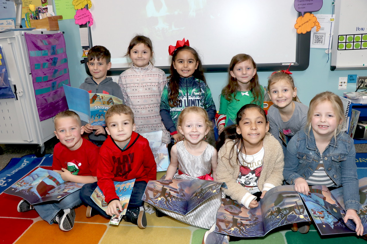 Students pose with donated books