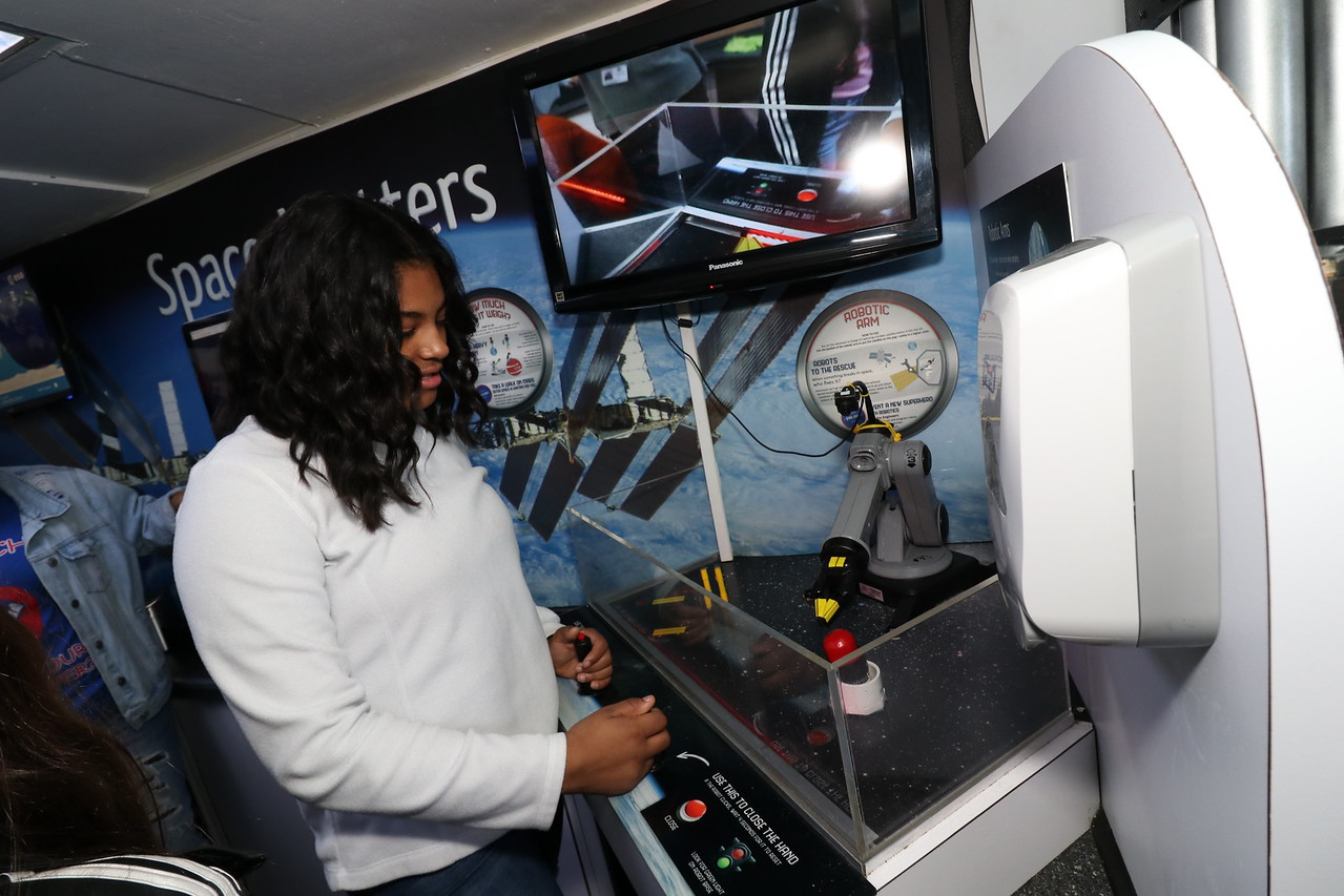 Student test robotic arm in STEM trailer.