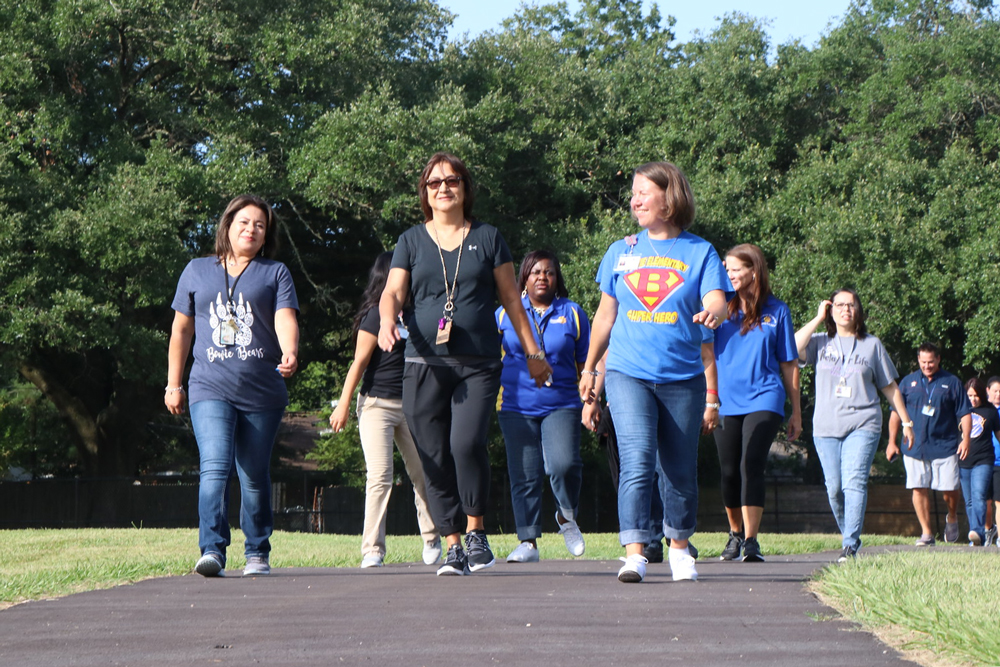 
Leticia Miranda, Maria Fadul, Sherry Morgan, Diane Slack, Leigh Ann Flowers, Leticia Chapa, Lance Mize and other employees from Bowie, Carver and Lamar elementary schools took the first official walk on the walking trail after the ribbon-cutting ceremony at Bowie. The walking trails at four Goose Creek CISD campuses, including Bowie, Carver, Lamar and Harlem, were projects of Be Well Baytown, an initiative of The University of Texas MD Anderson Cancer Center, sponsored by ExxonMobil.
