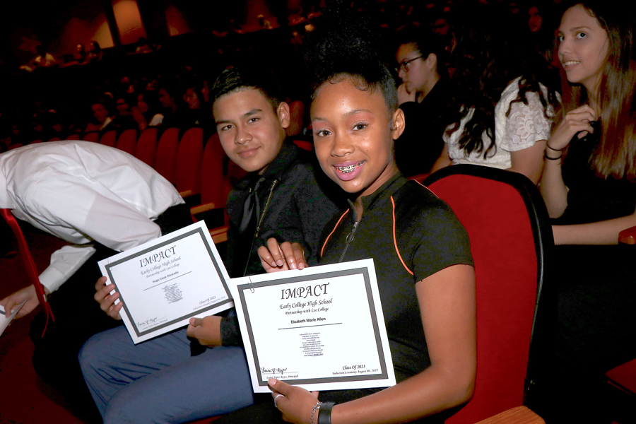 
Hugo Alvarado and Elizabeth Allen proudly display the certificates they received as they were inducted into IMPACT Early College High School.

