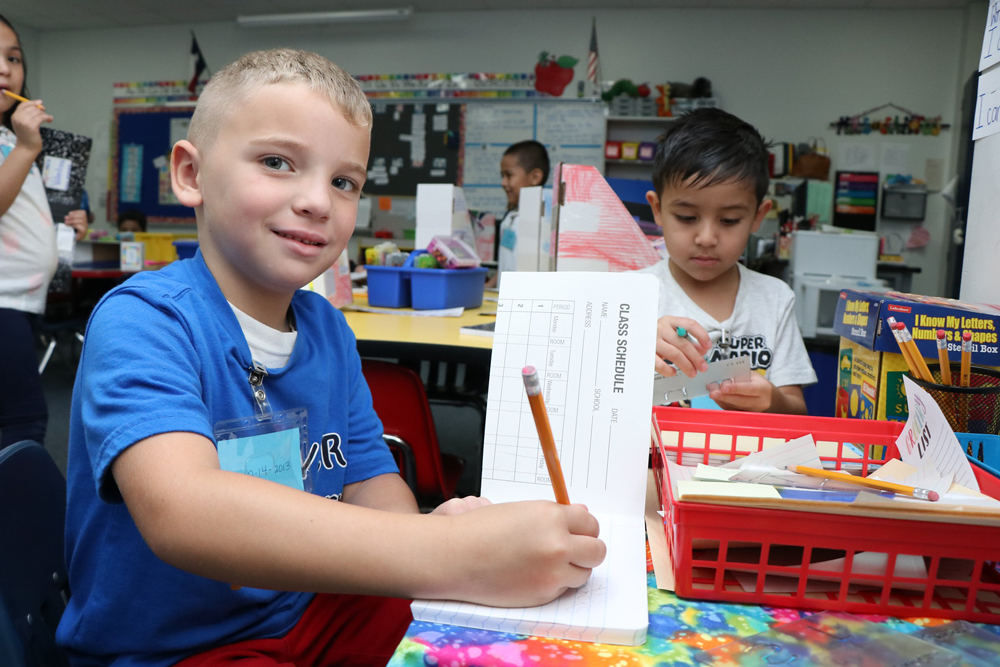 
Sandra Santos, the English teacher for the Dual Language Two-Way Program at Carver Elementary, works with (from left) Levi Richard and Joselin Hernandez at a station.
