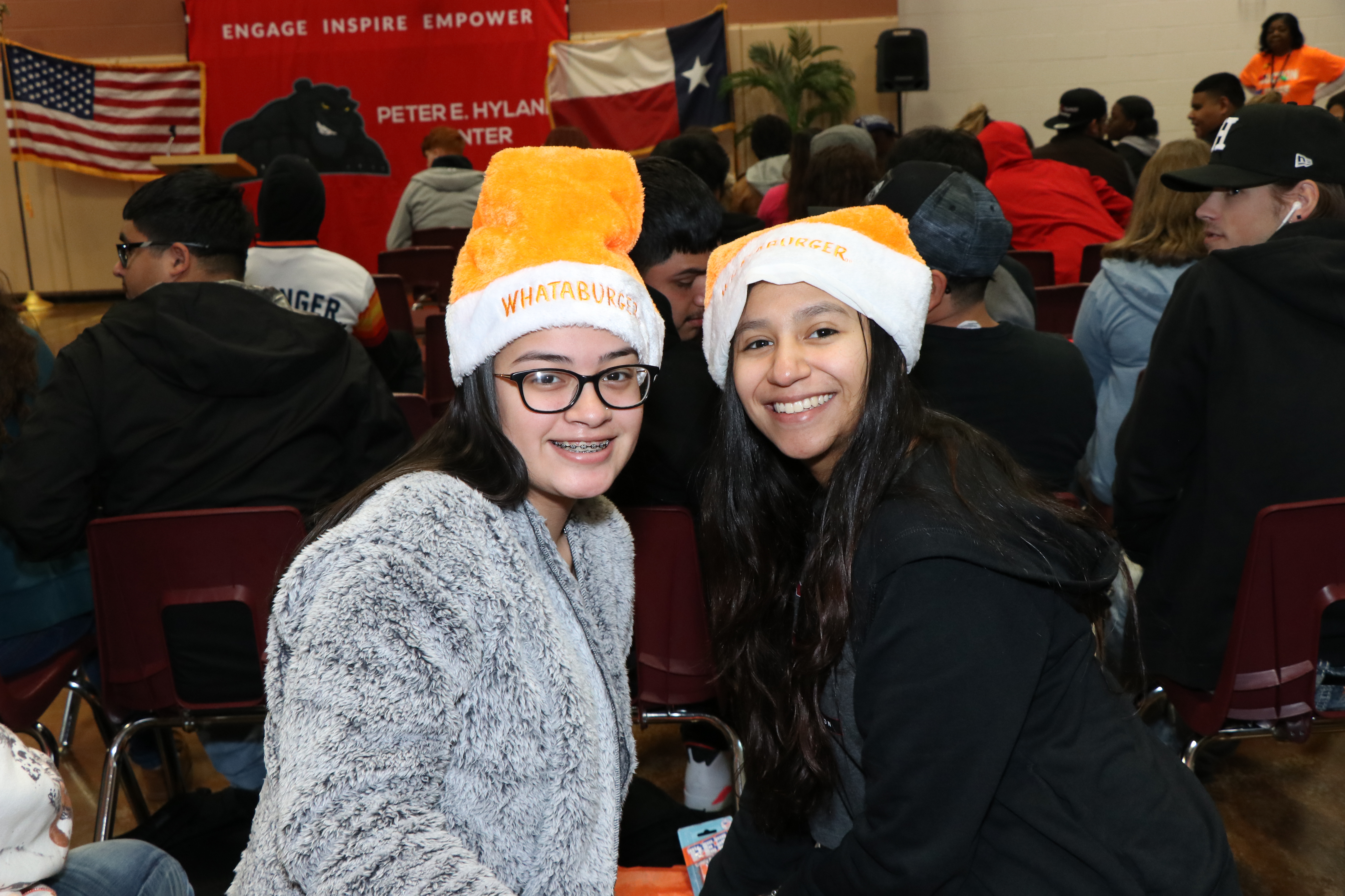 Students wearing whatburger hats they won at the auction.