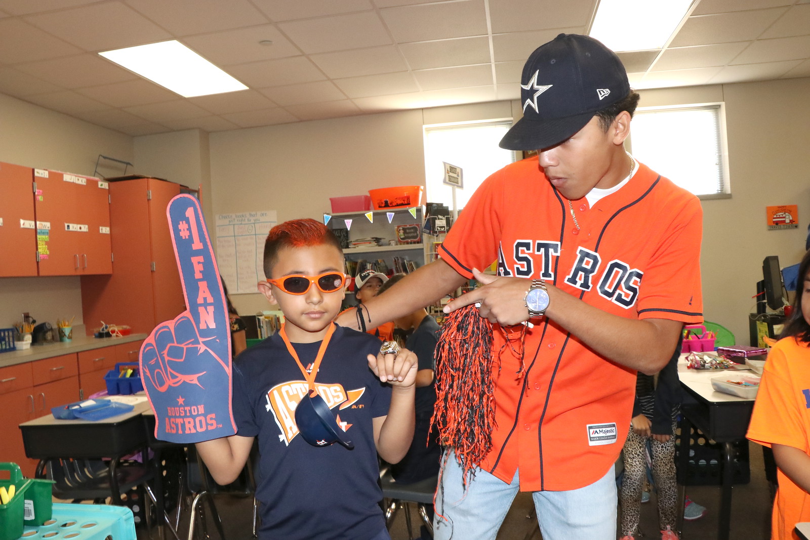 Gadiel Chavez (left), third-grader at Travis Elementary, shows off his Astro spirit to Robert E. Lee High School baseball player Izayah Hernandez.