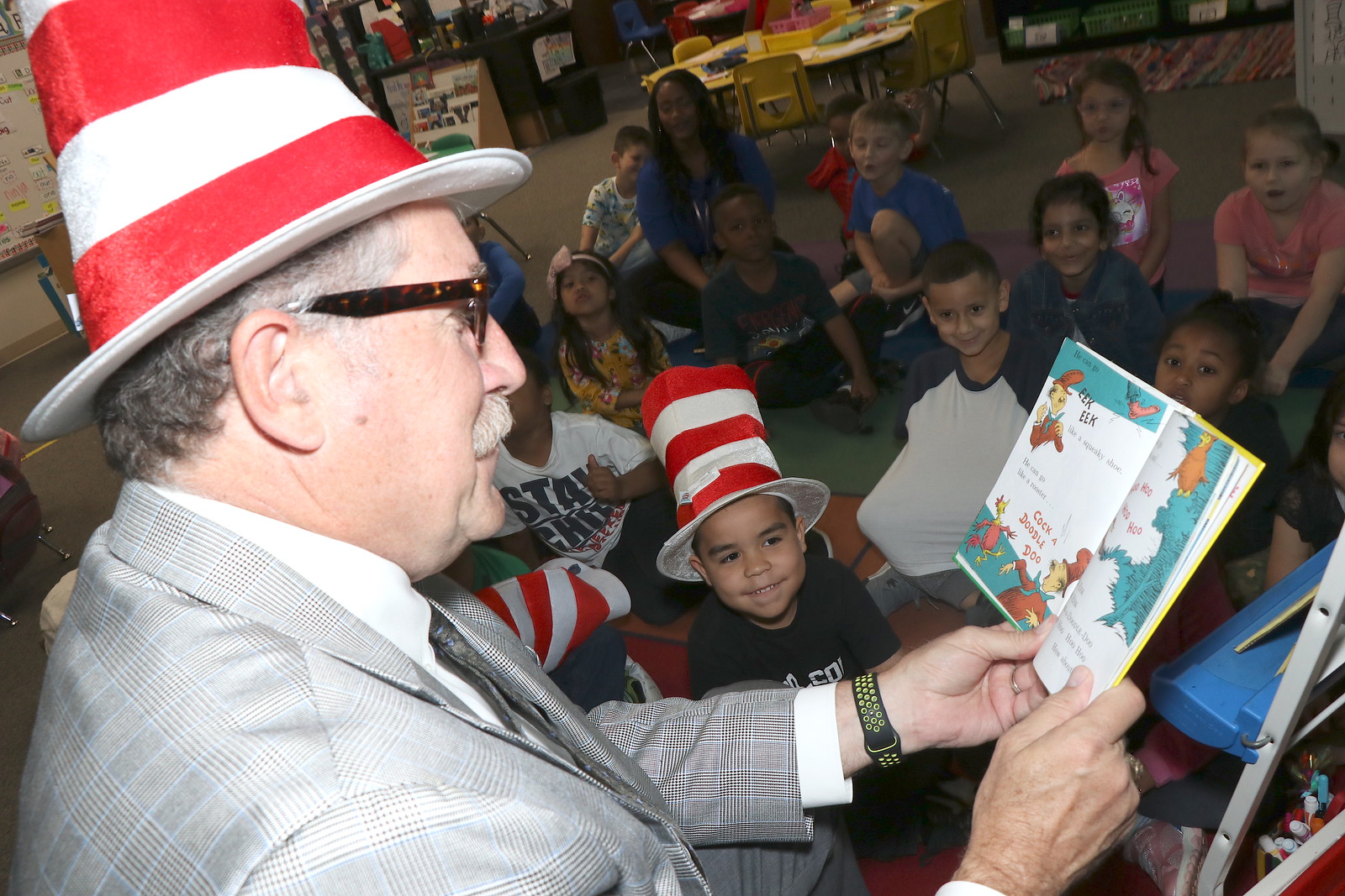 Obrien reads dr seuss book to students