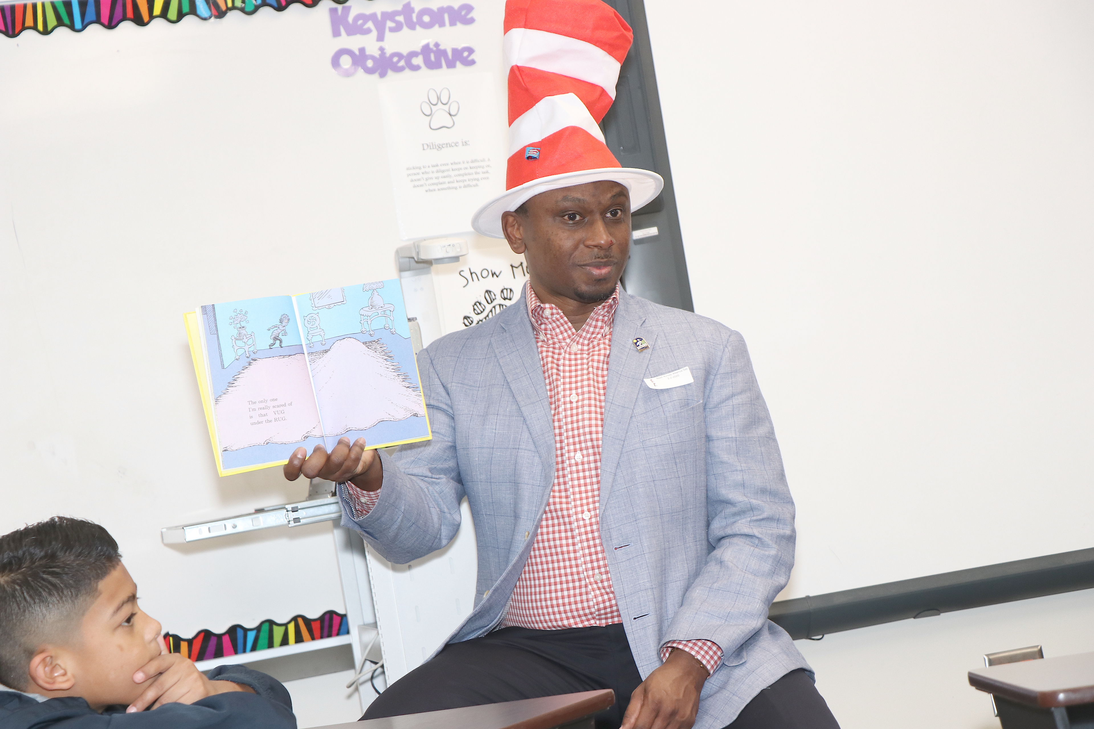 Charles Johnson Reads Dr Seuss book to students
