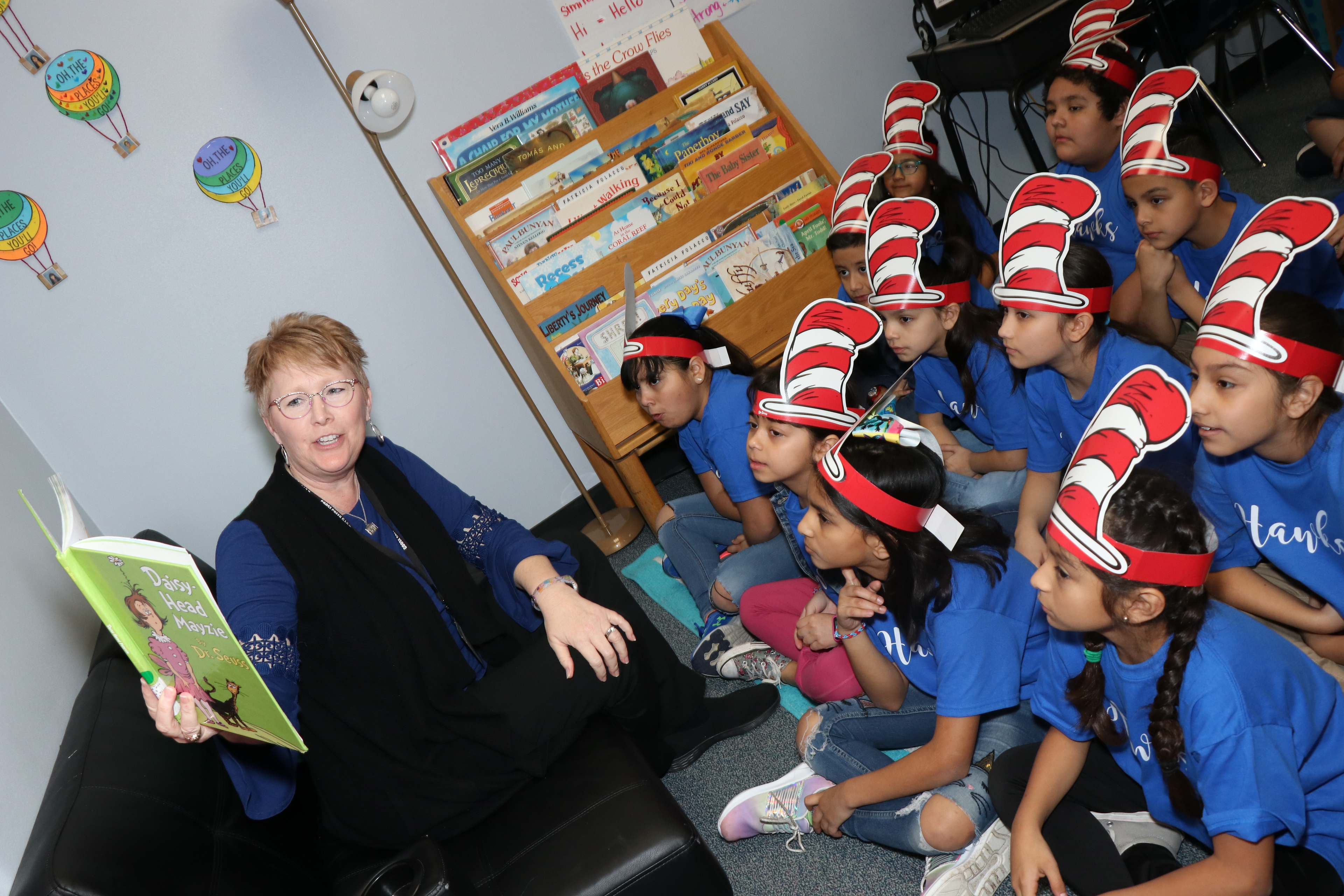 christi leath reads dr seuss book to students