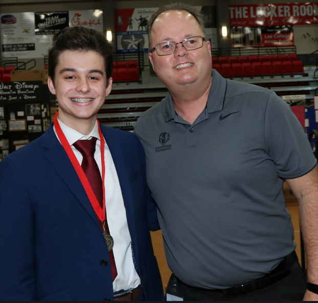 Adam Kinder standing with Steve Koester