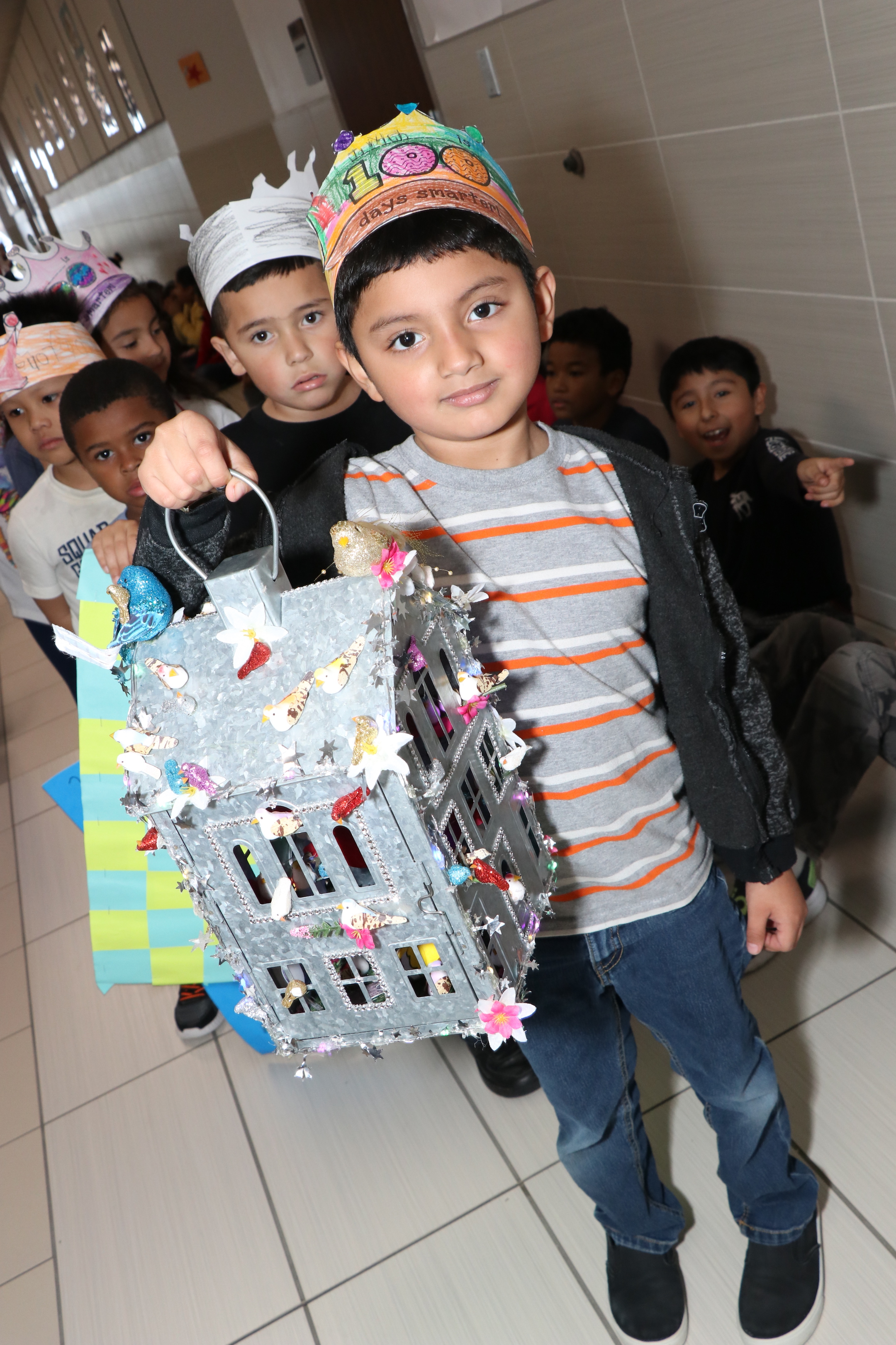 Student holds house with 100 birds