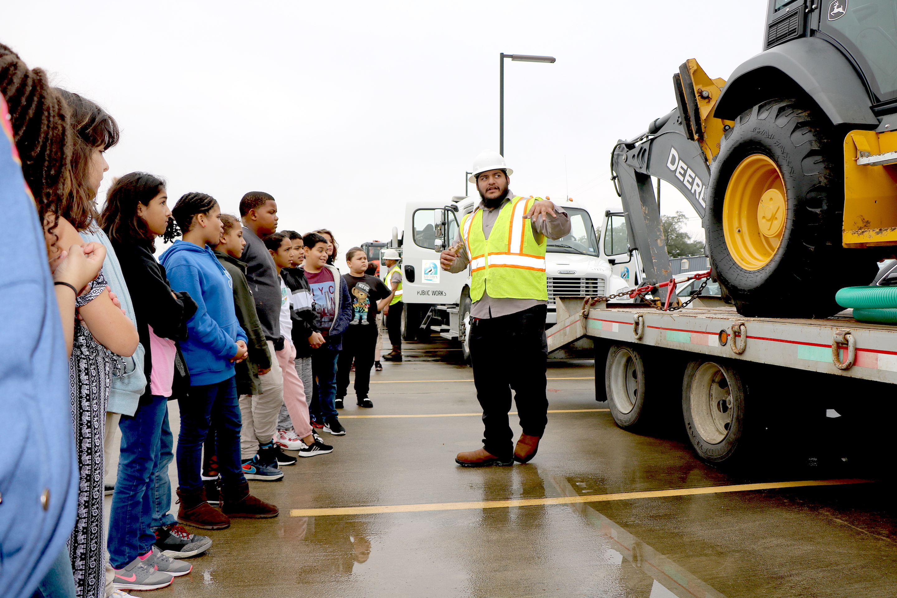 Students listen to city worker talk about equipment.