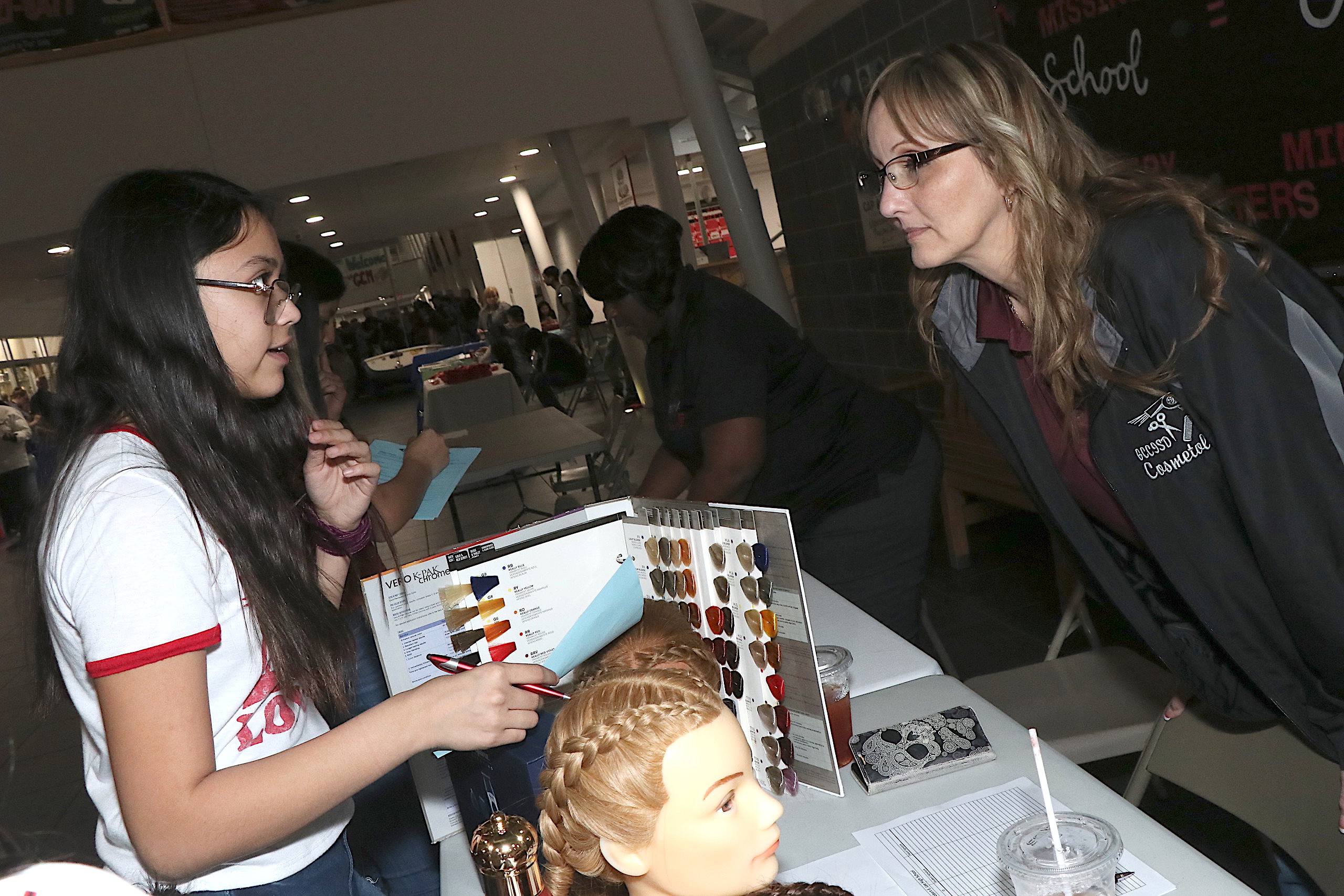 Student discusses cosmetology with teacher