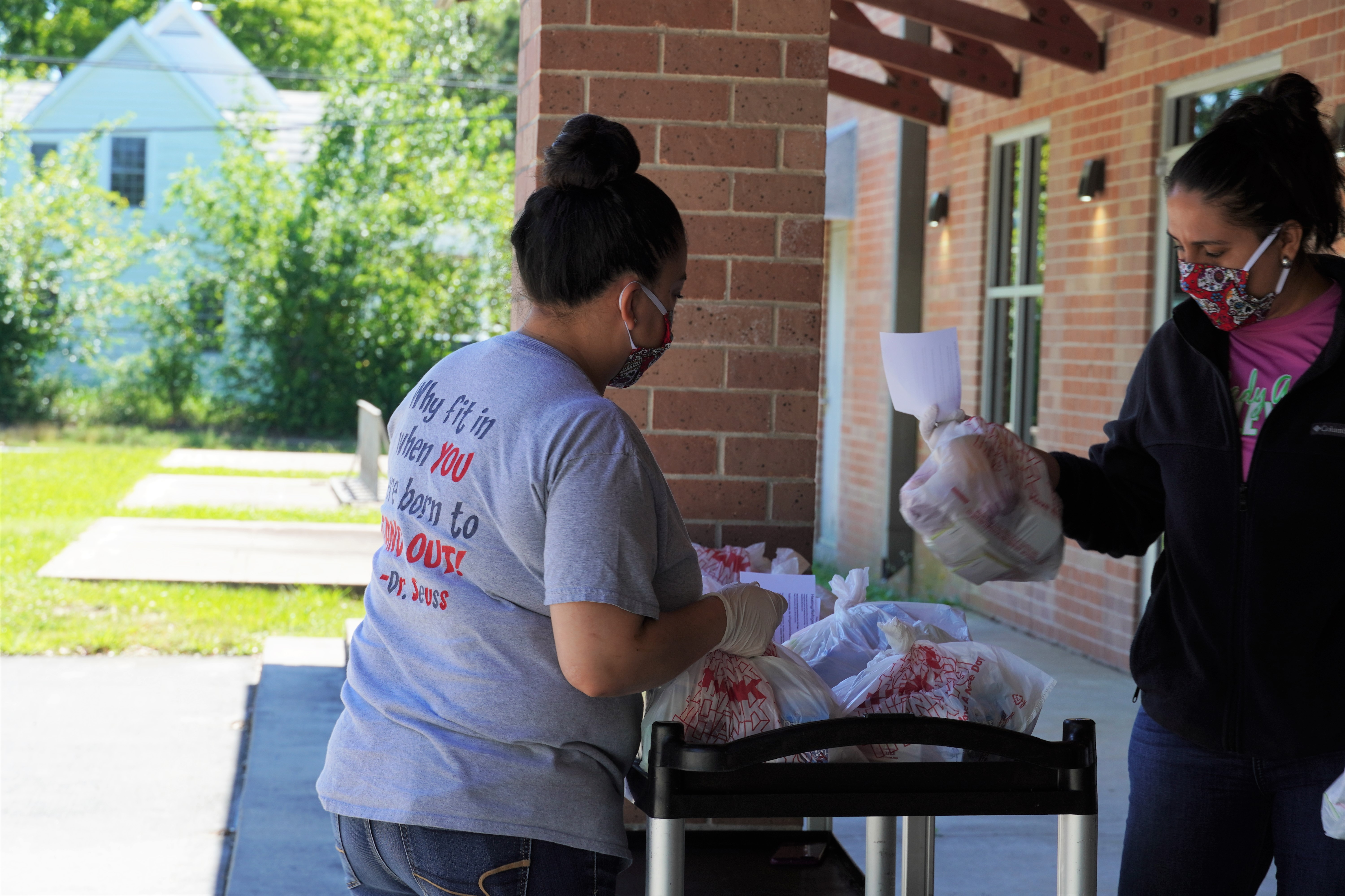 Nutrition services staff hand out food