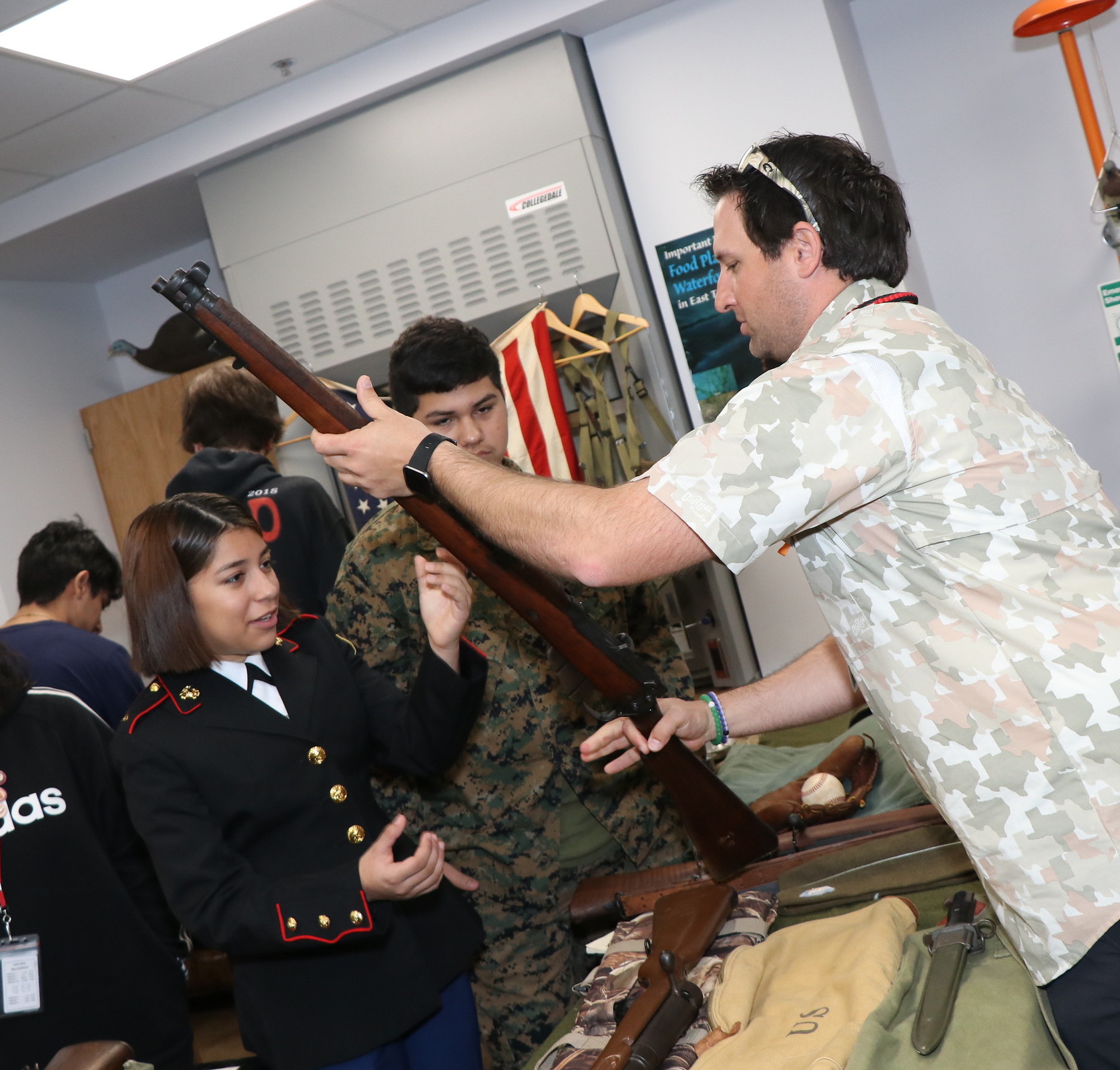 Teacher shows student disabled WWII Rifle