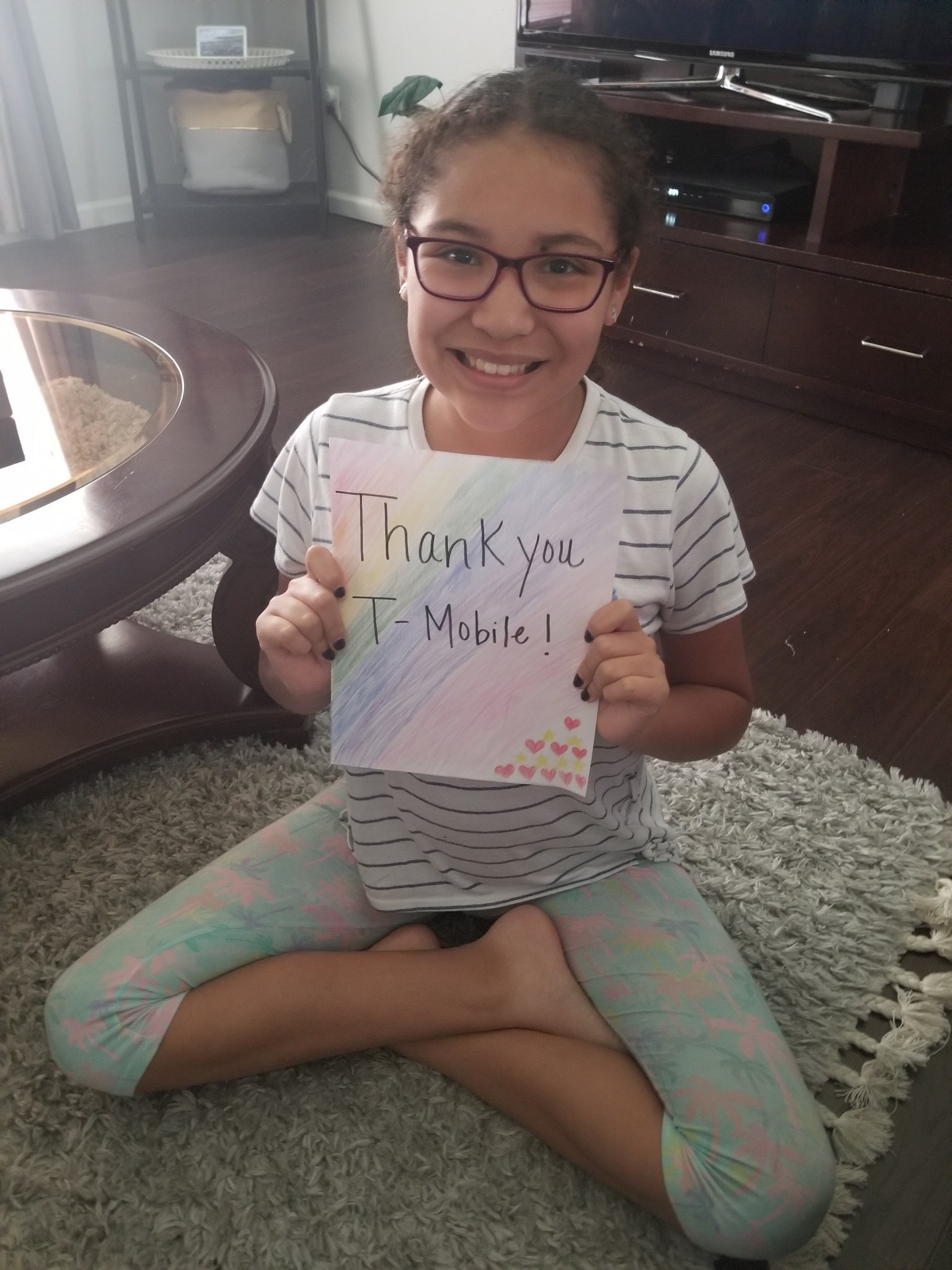 Student holds sign to thank T-Mobile