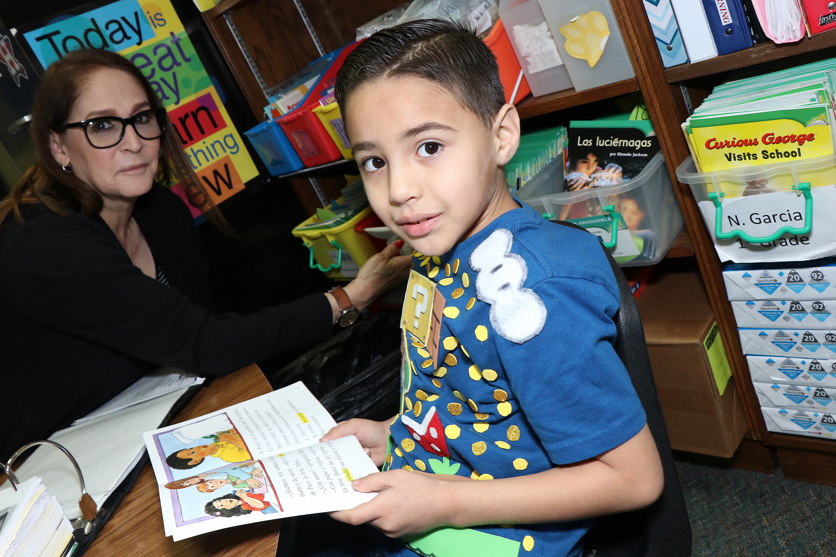 Students reads to teacher