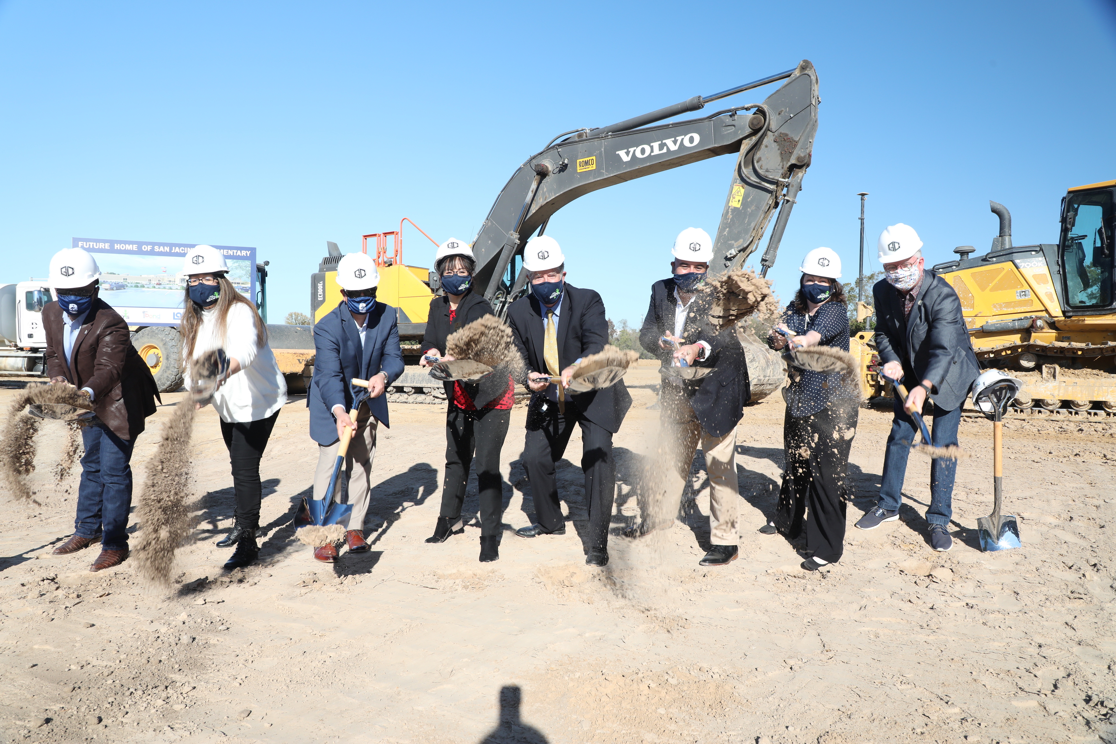 Executive Council throwing dirt at ground breaking