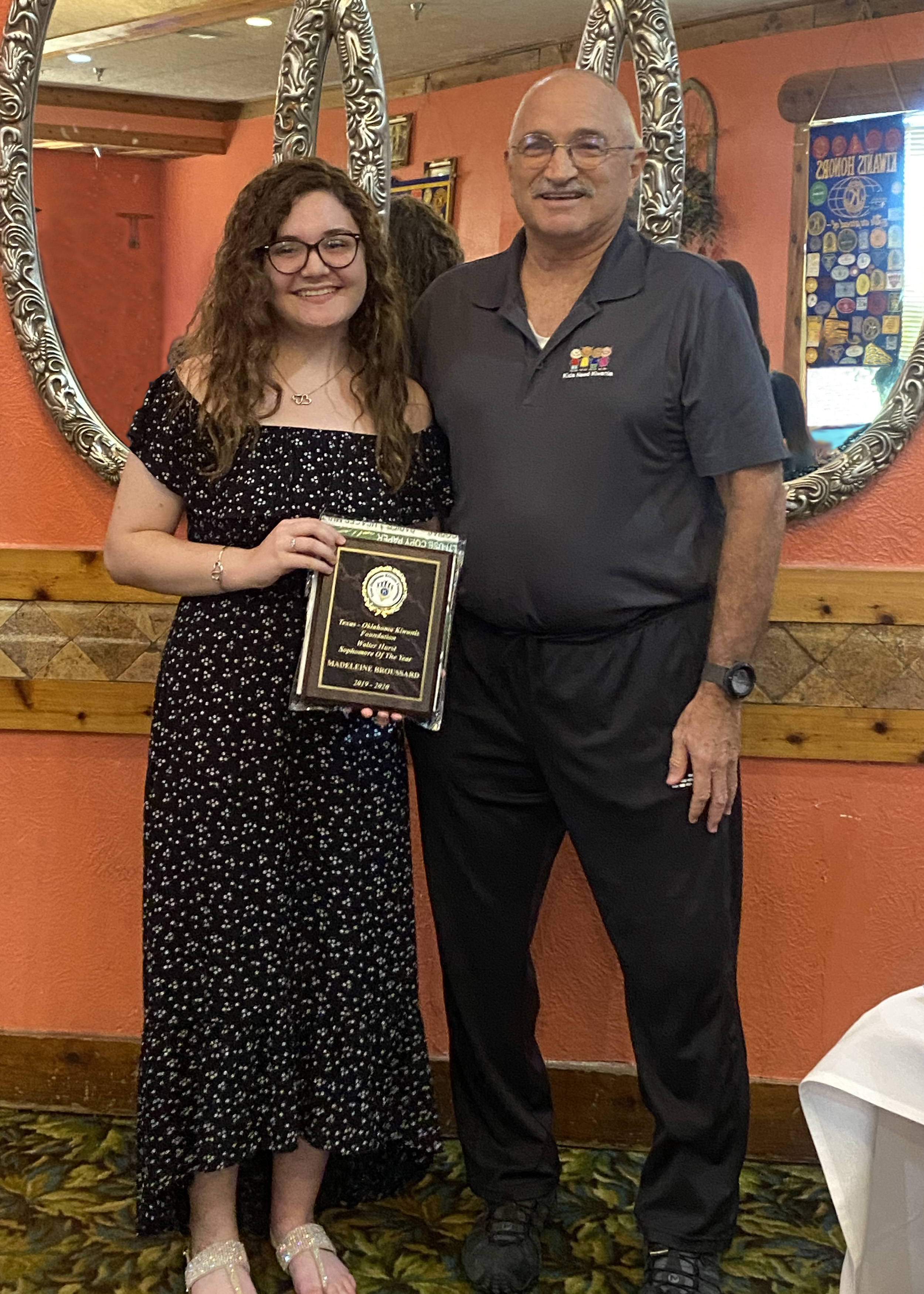 Madeleine Broussard is congratulated by Kiwanis District 28 Lt. Governor Greg Samford