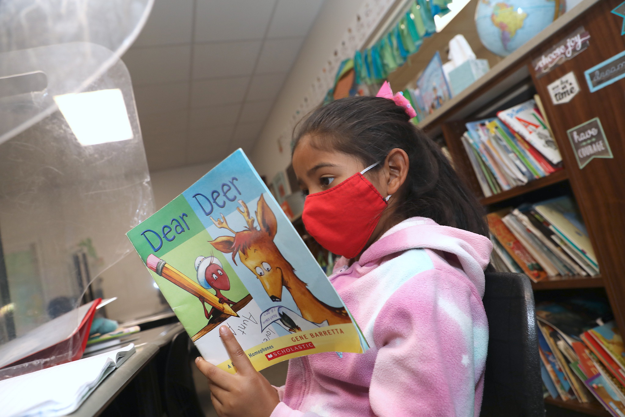 Amaya Santiago, second grade, concentrates on reading her book.