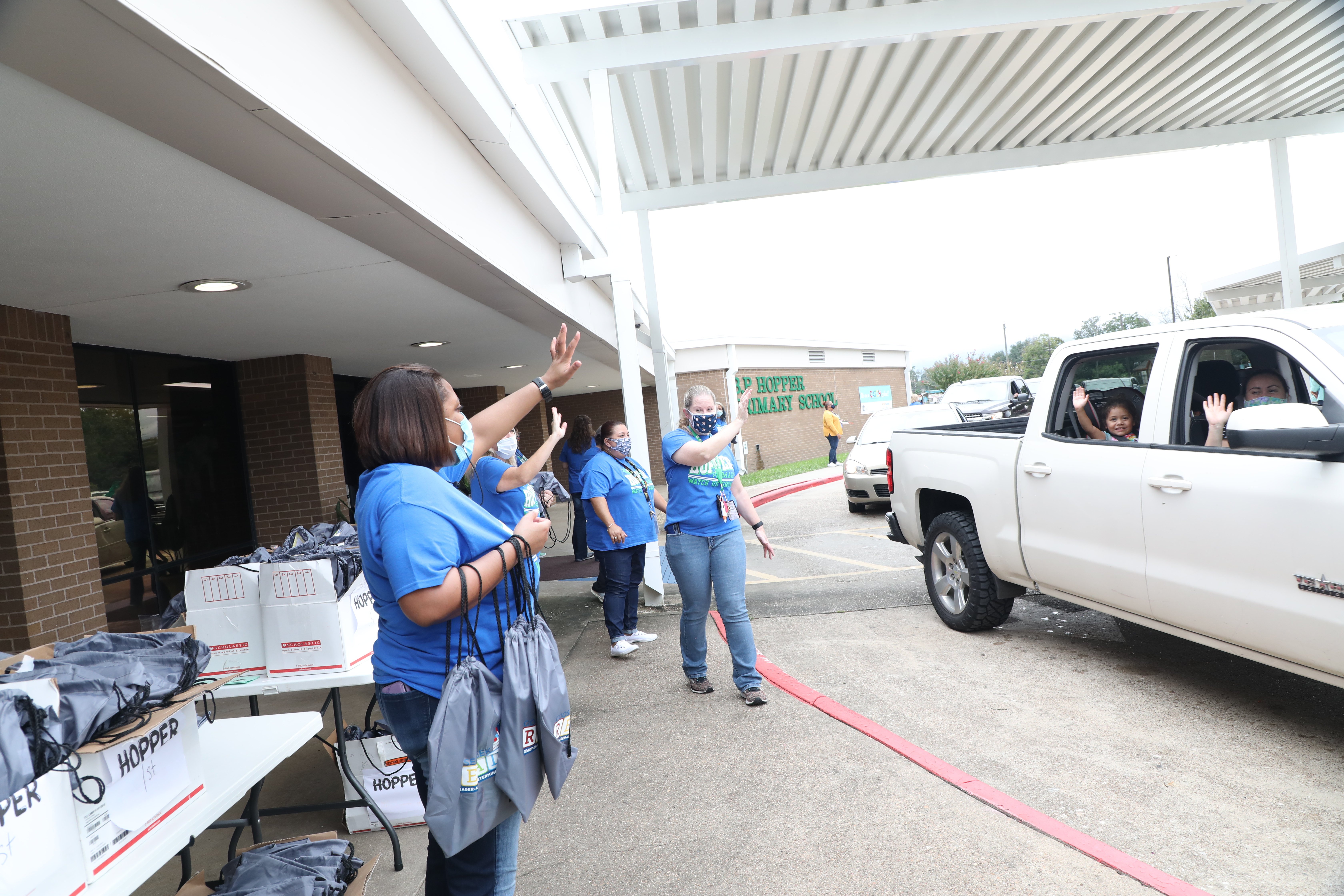 Teachers Greet Students in Vehicles