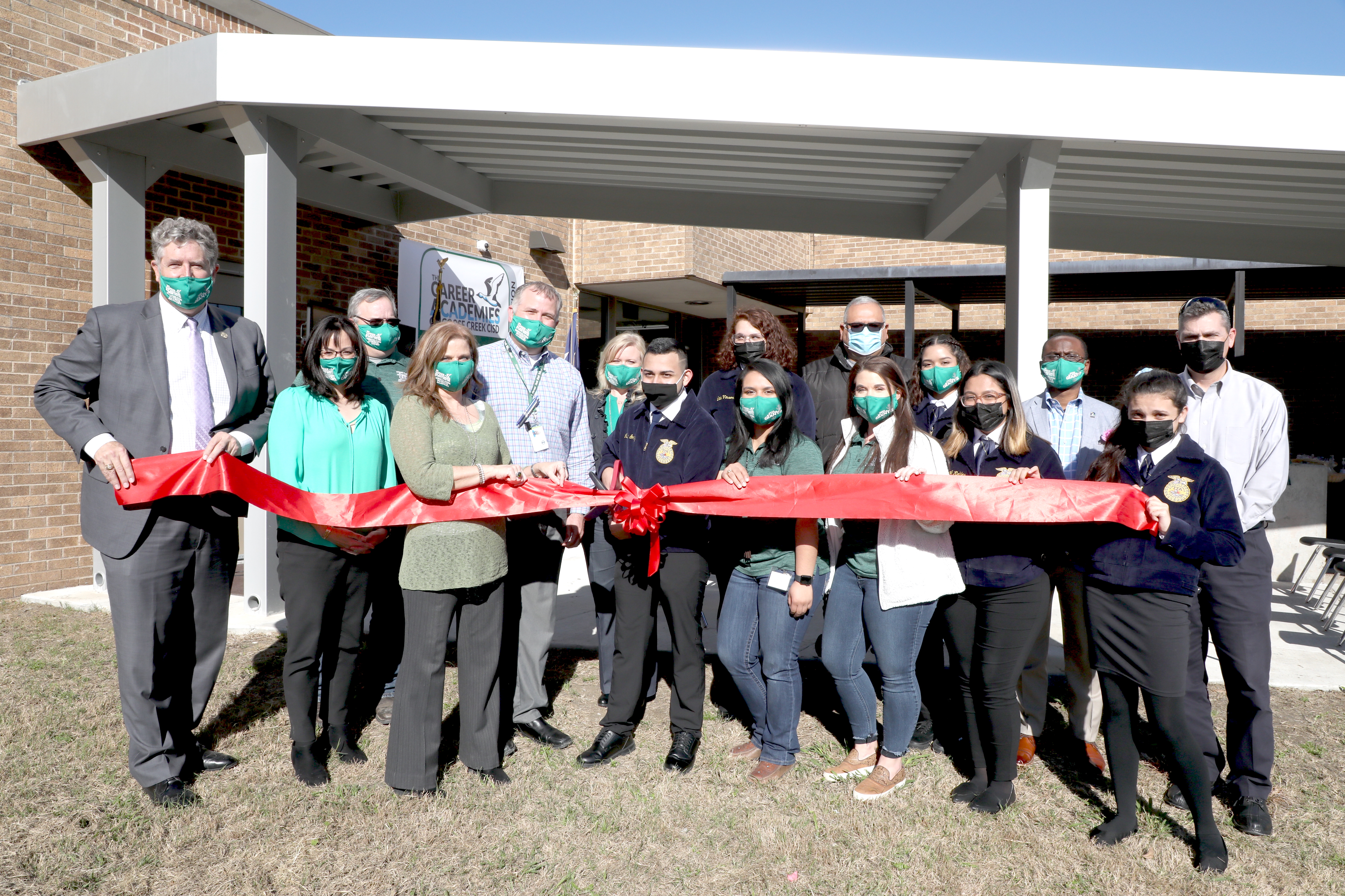 Staff, students and community members cut ribbon for new facility.