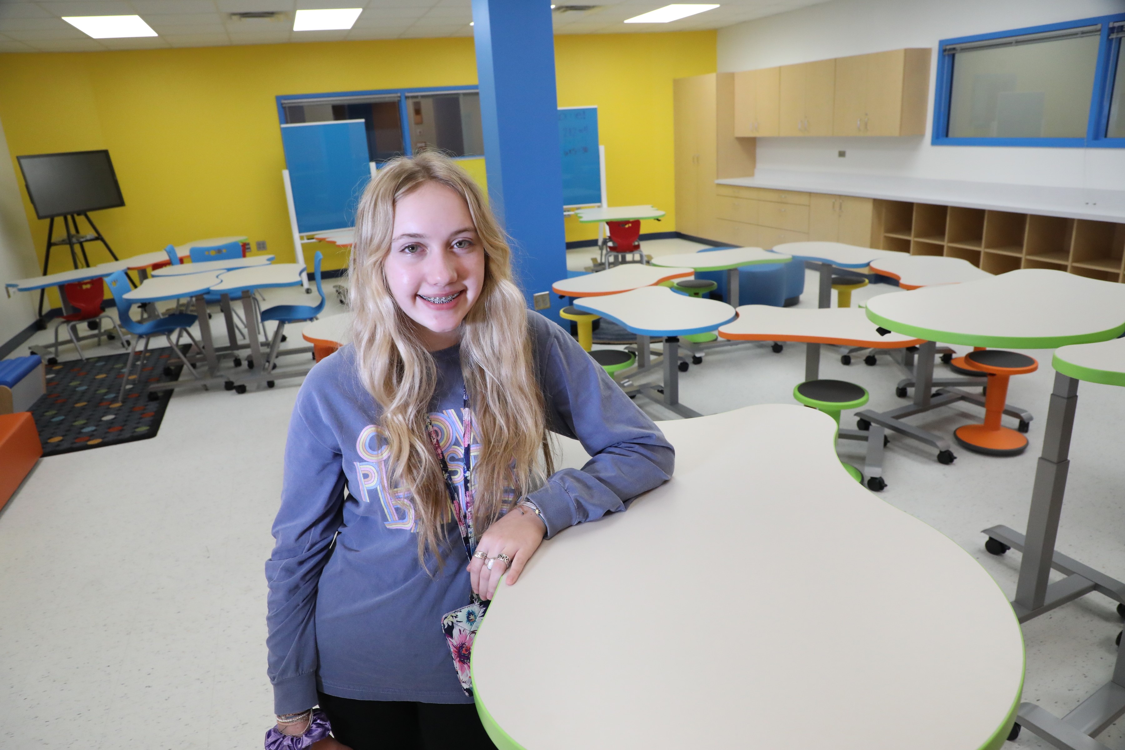 Student stands at table in classroom lab