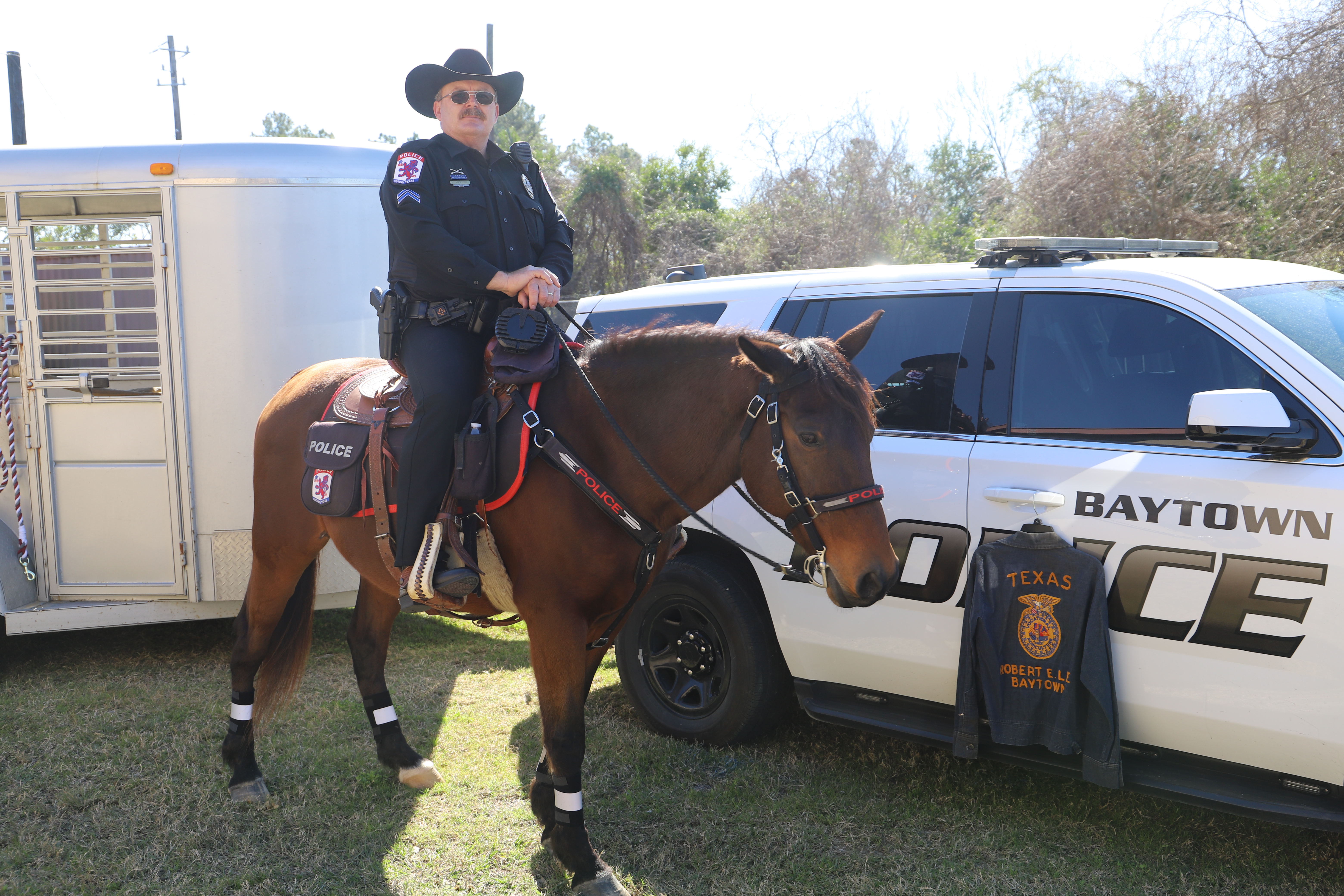 Baytown Police Officer Norman Anderson poses on his horse in front of his patrol vehicle