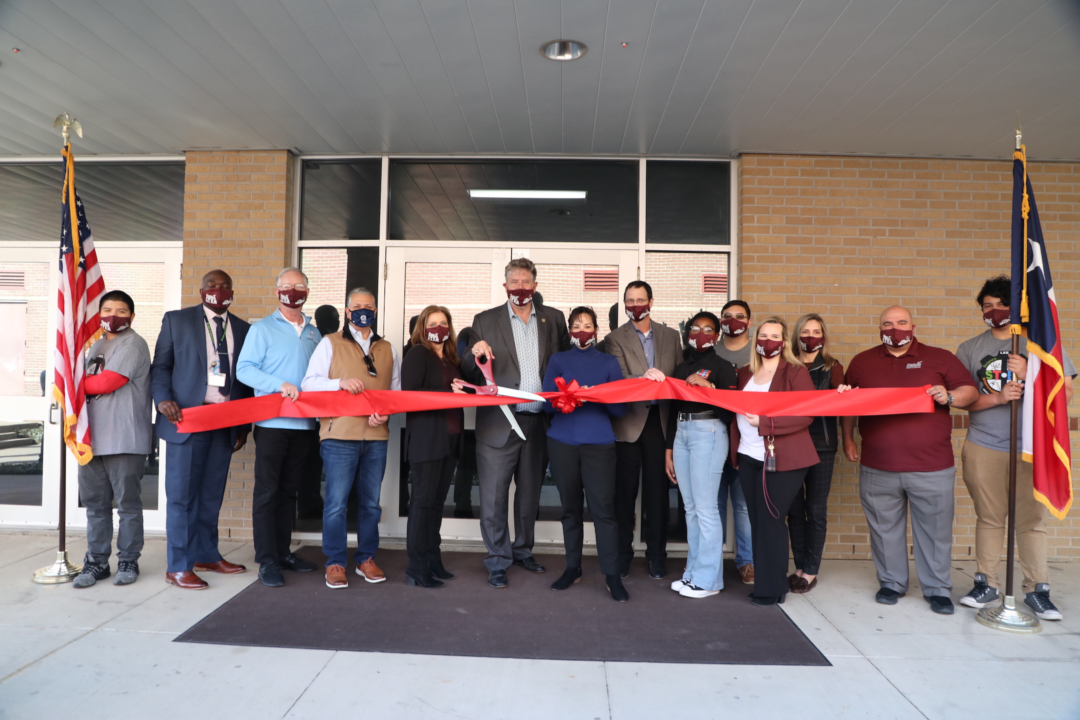 staff and community members cut ribbon