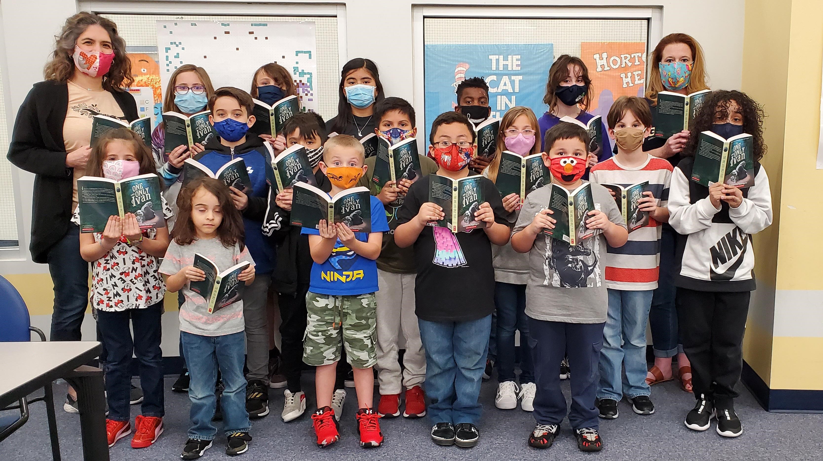 Students stand with books 