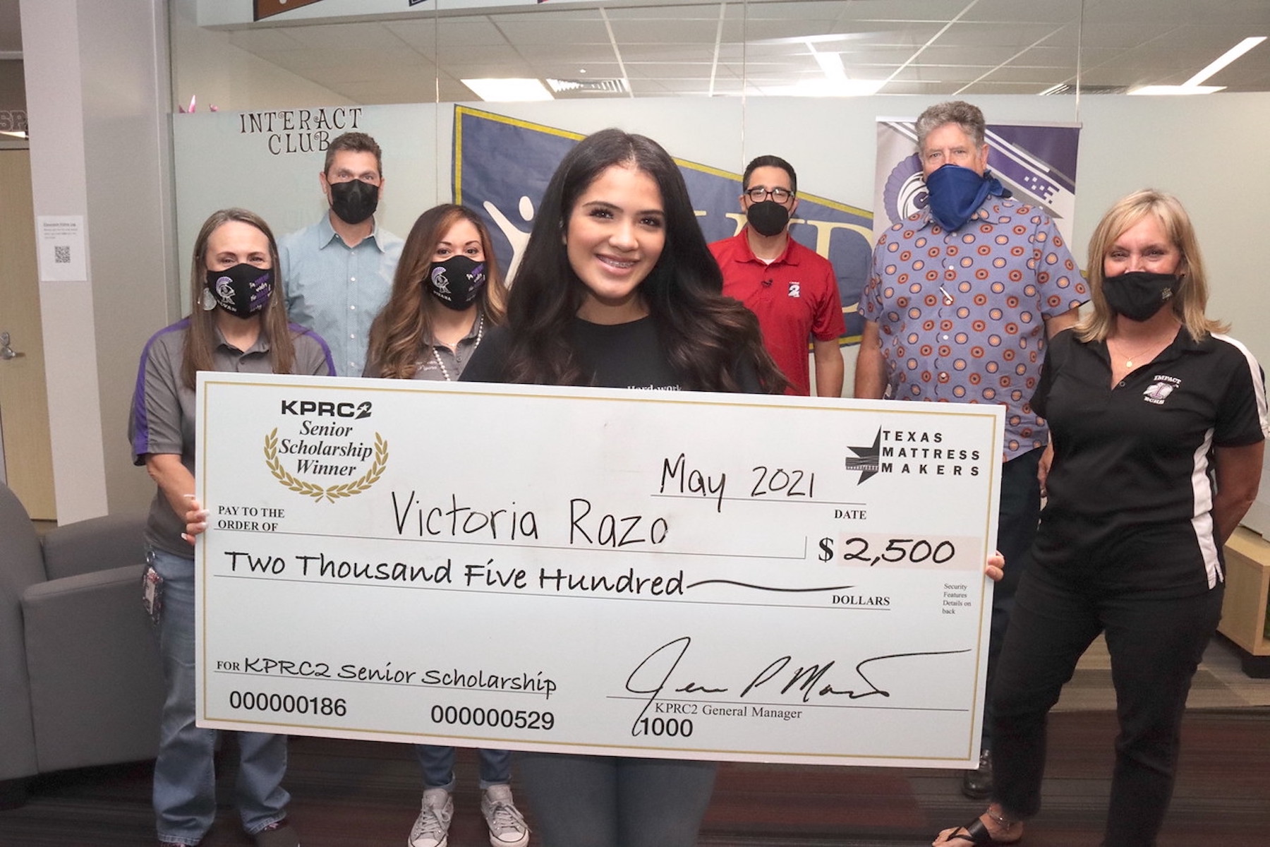 IMPACT student poses with channel 2 giant scholarship check