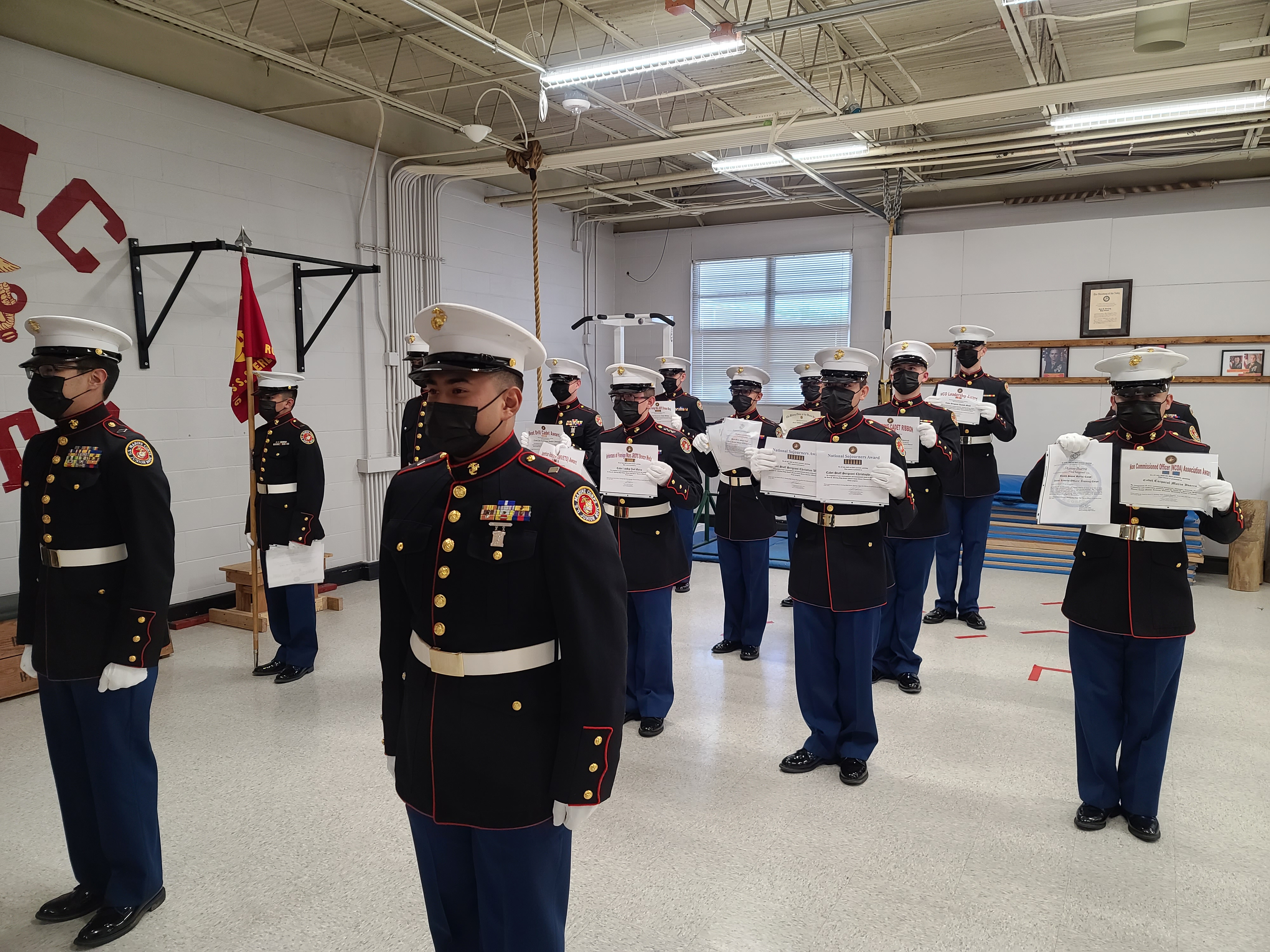 boys drill team holds their award certificates