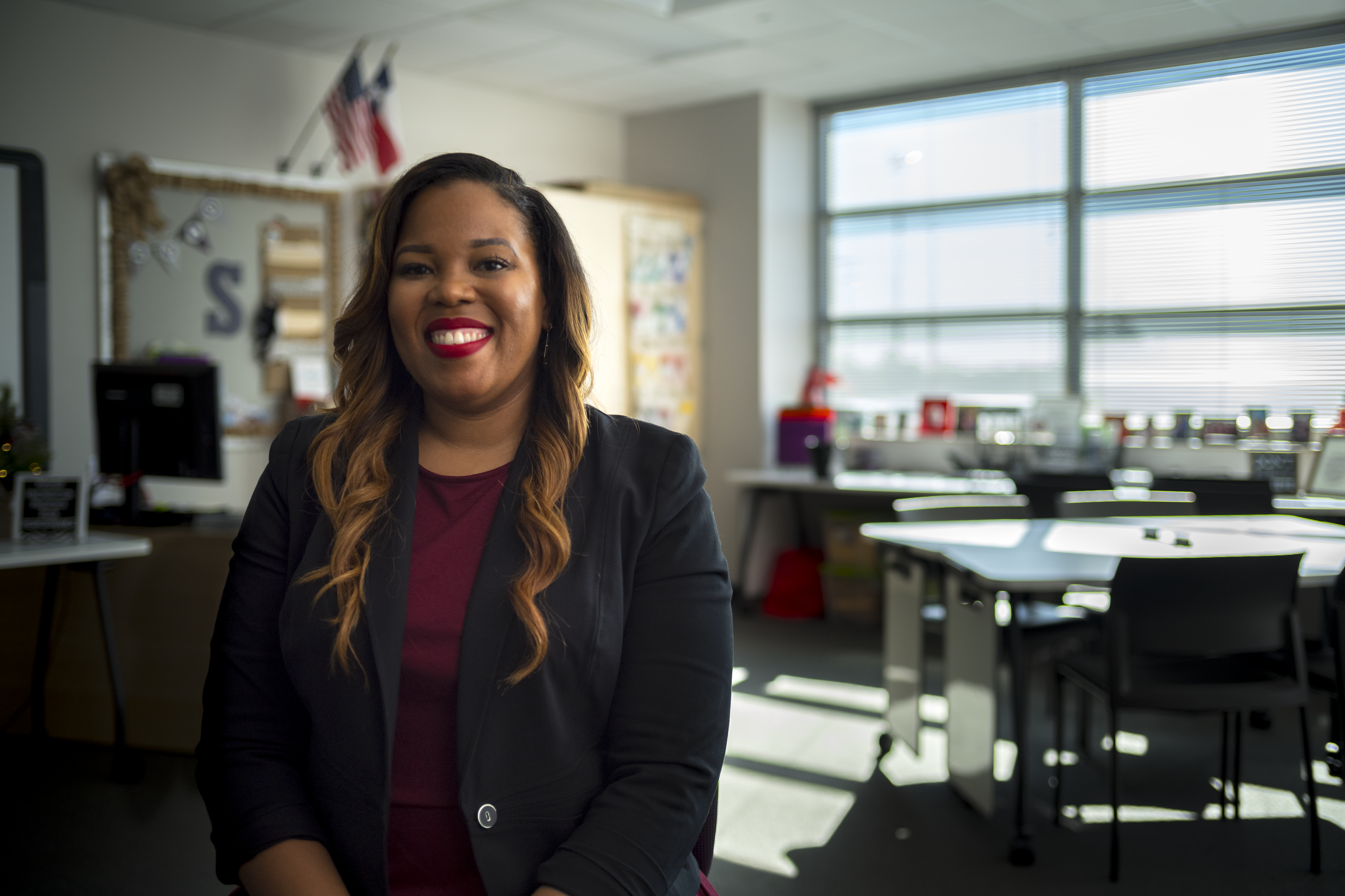 teacher poses in front of camera in a classroom