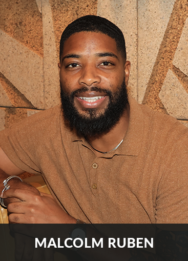 Malcolm Ruben in front of restaurant wall