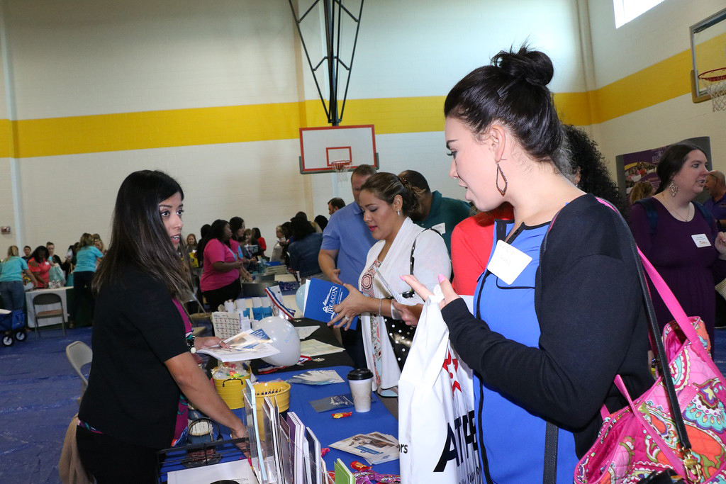 
New Goose Creek CISD teachers Chad Promise (left) and Marianna Hammel discuss furthering their education with Jessica Halter, Lamar University Academic Partnerships representative, at the recent New Teacher Vendor Fair.
