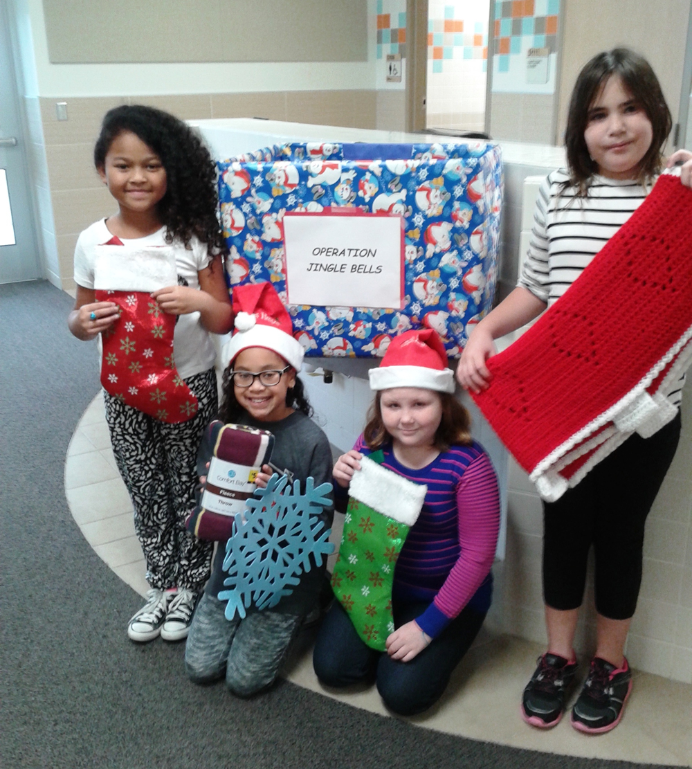 Four Bañuelos students pose for Holiday photo