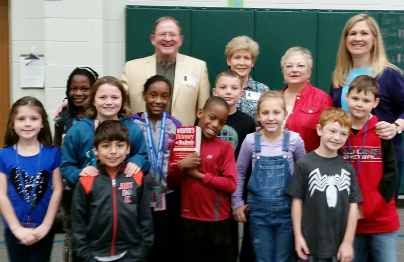 Clark student holds dictionary donated to school