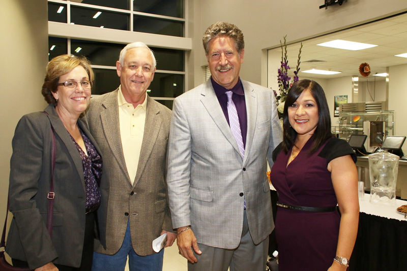 former principal and superintendent stand with current principal and superintendent