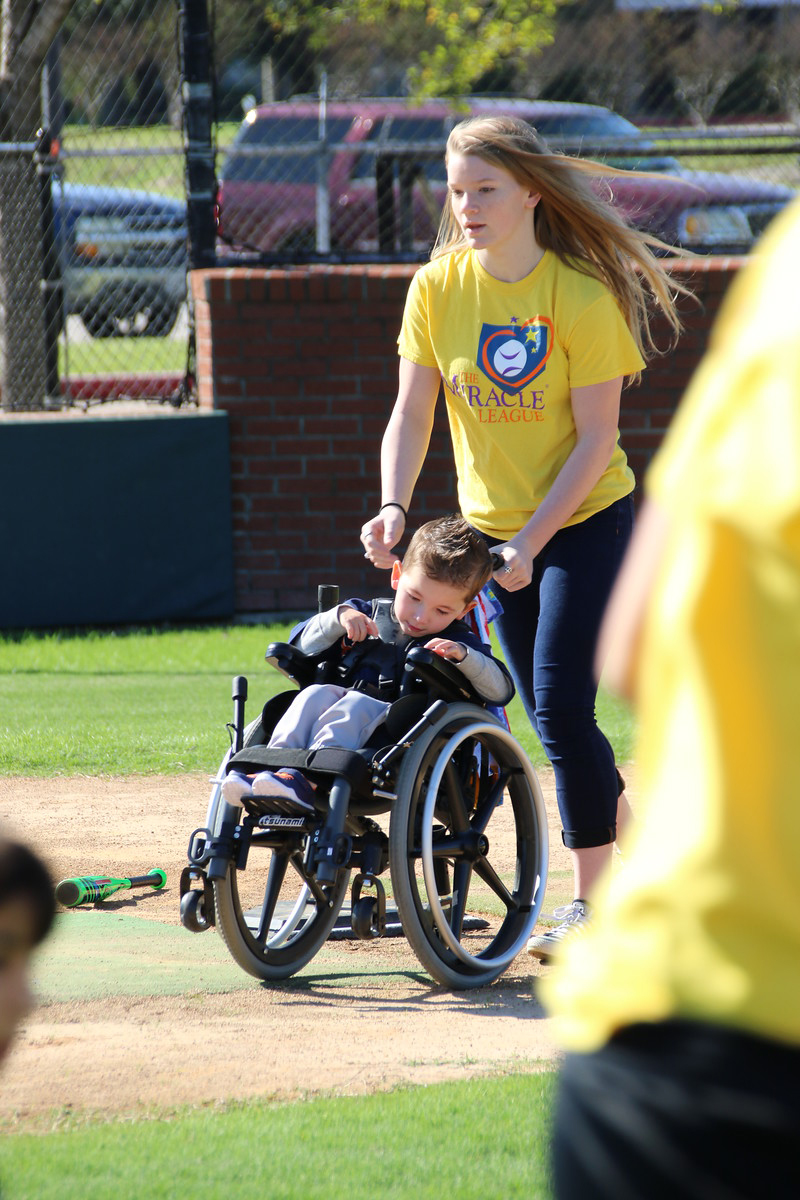 High School student helps miracle league Member run the bases