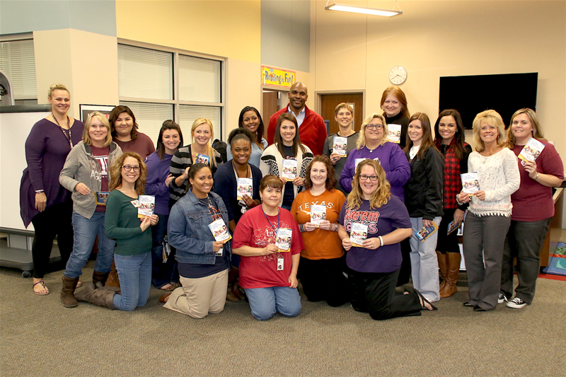 Randy Hall (back center) from Walmart passed out $50 reward cards to 20 randomly selected teachers f