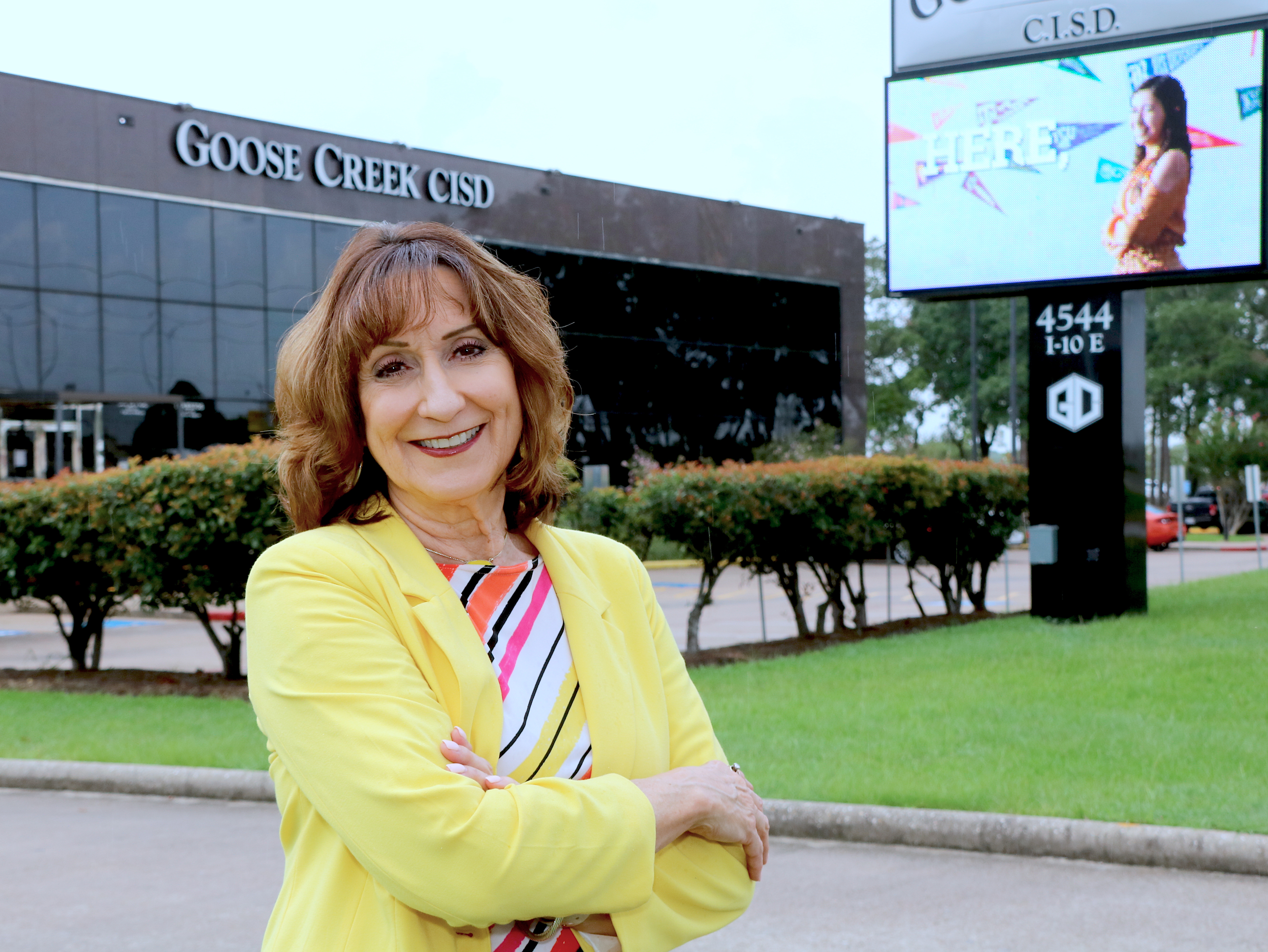 Susan Passmore stands in front of administration building