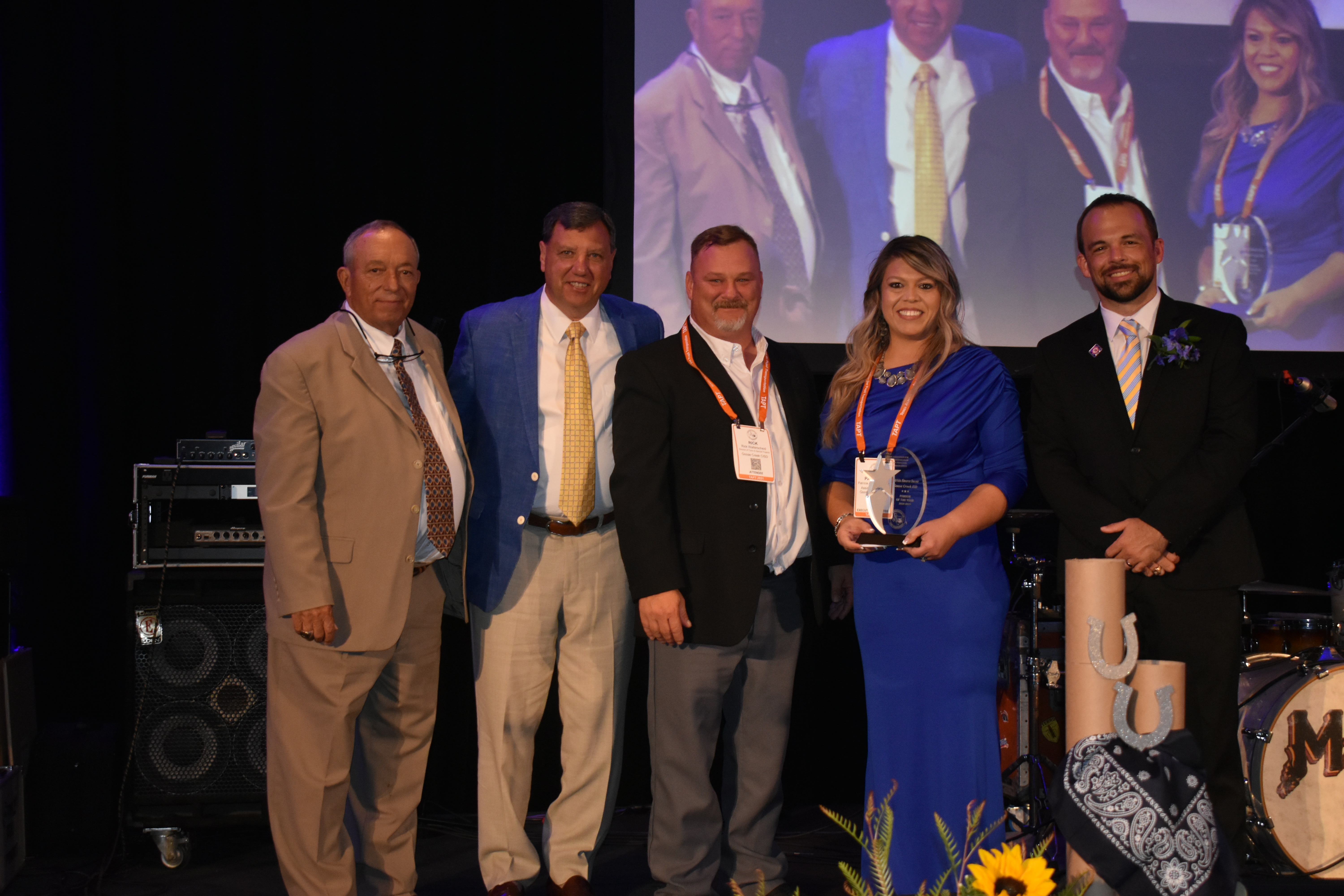 Transportation posing with award on stage