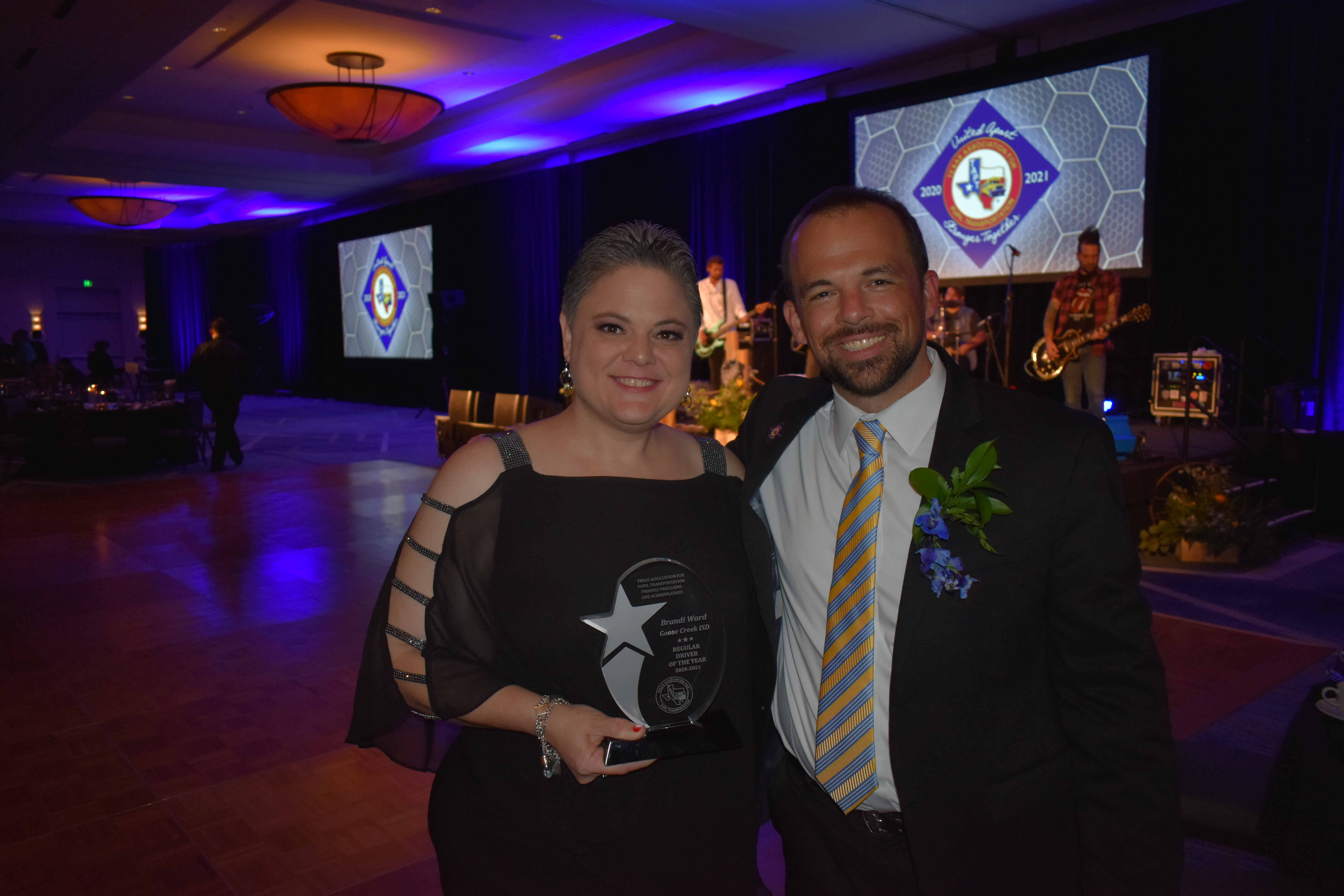 Transportation employee poses with award