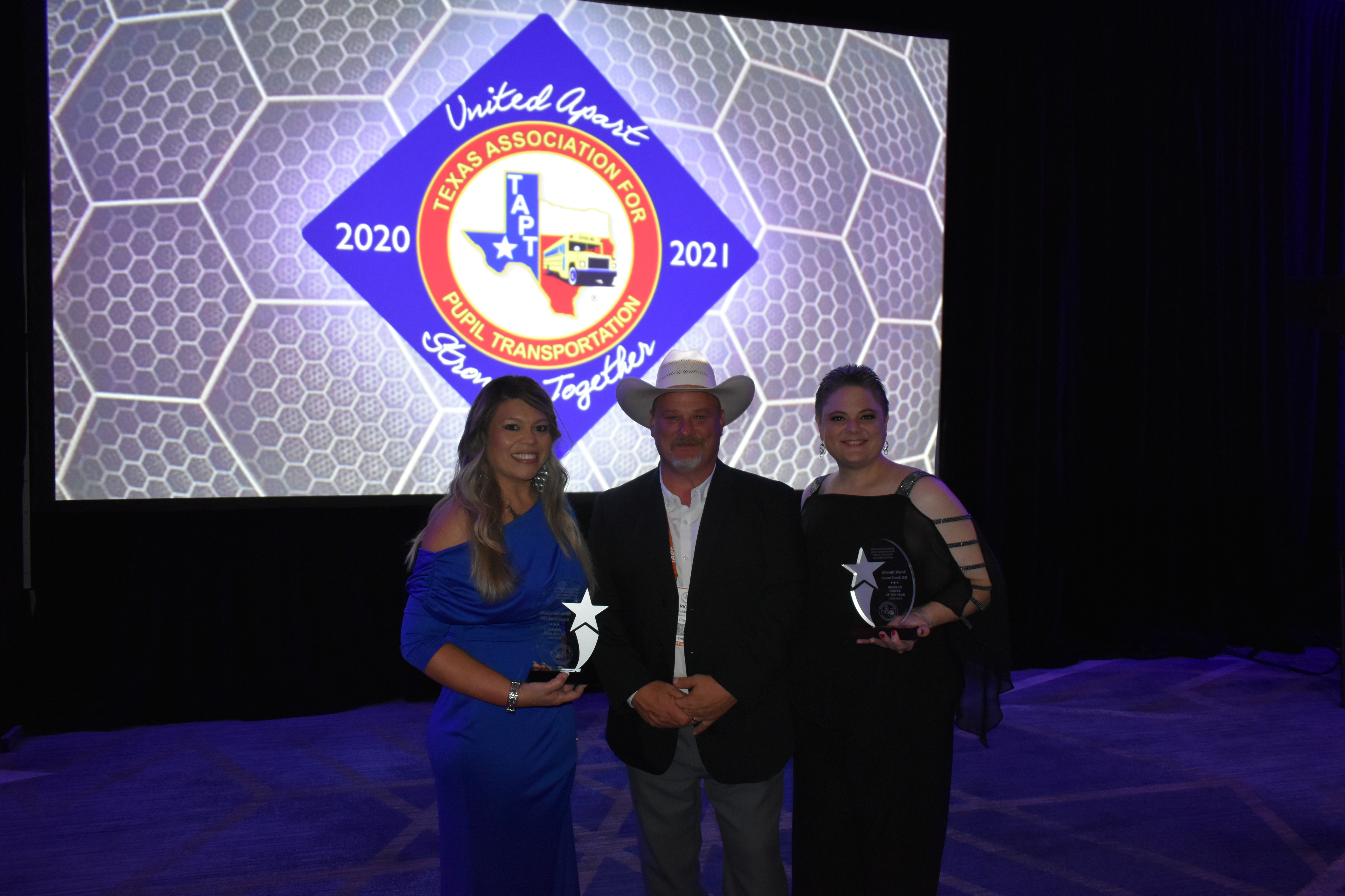 Transportation director and award winners pose with awards