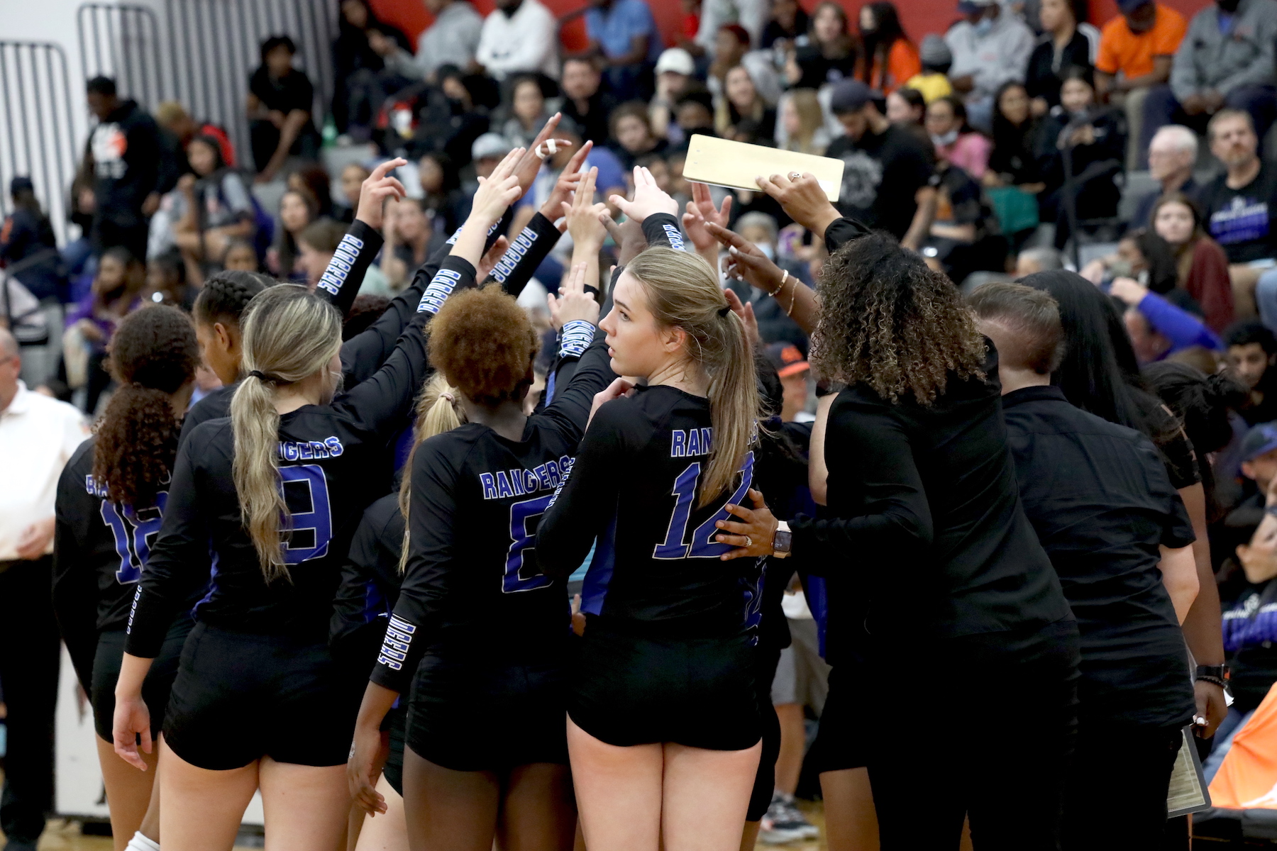 sterling volleyball players huddle to discuss next play