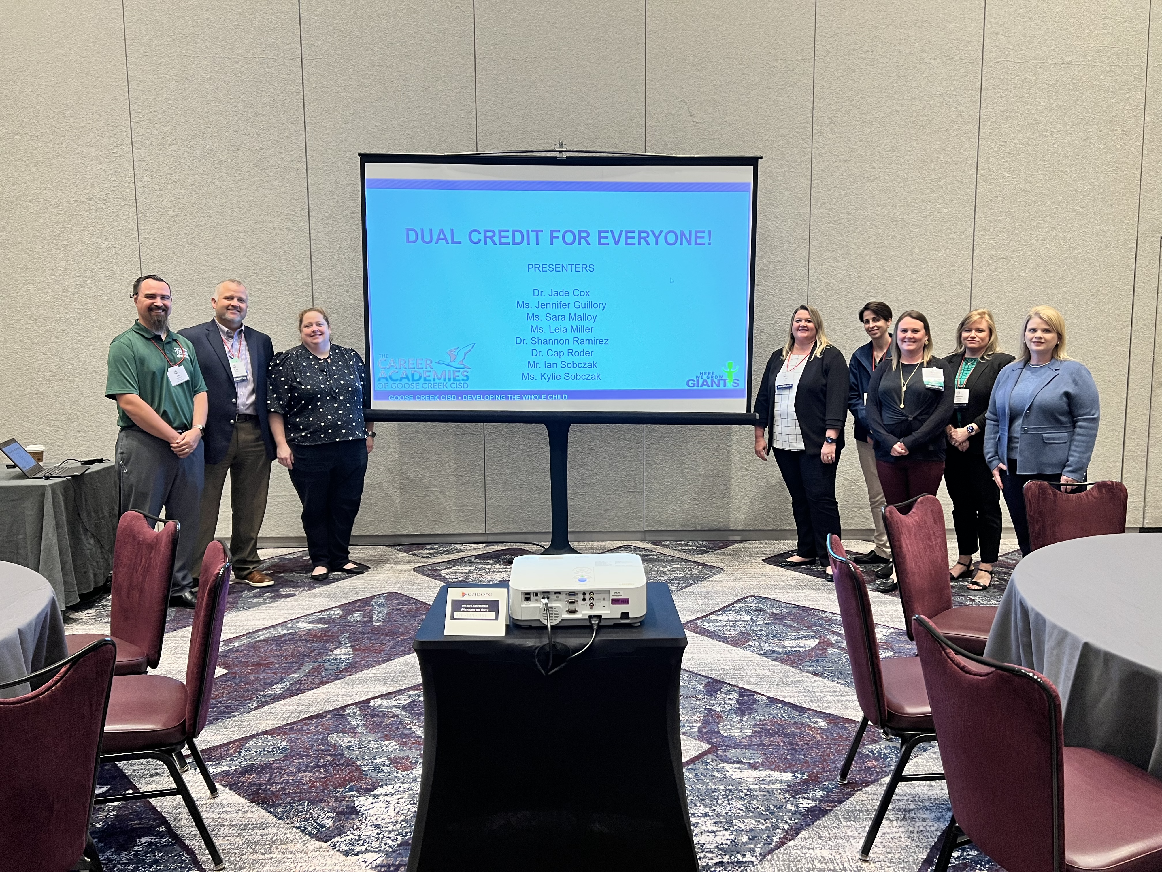 SCTHS staff stand in front of presentation