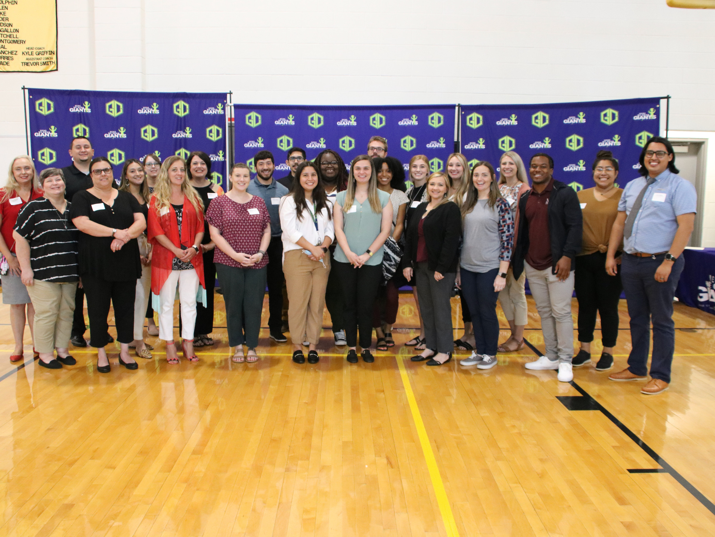 second set of alumni returning to teach pose for picture