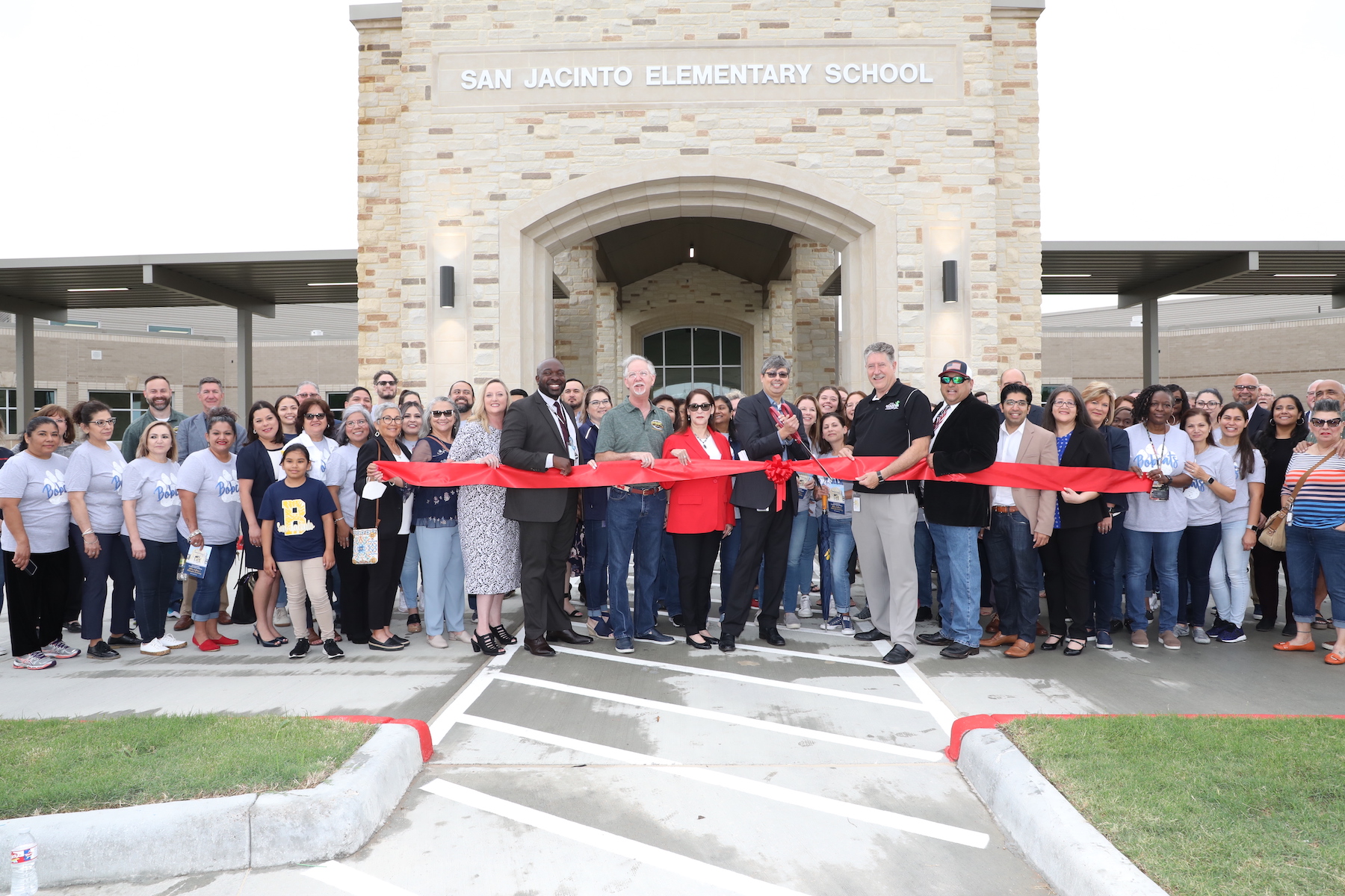 SJE staff, community and GCCISD admin and board gather together to celebrate the ribbon cutting 