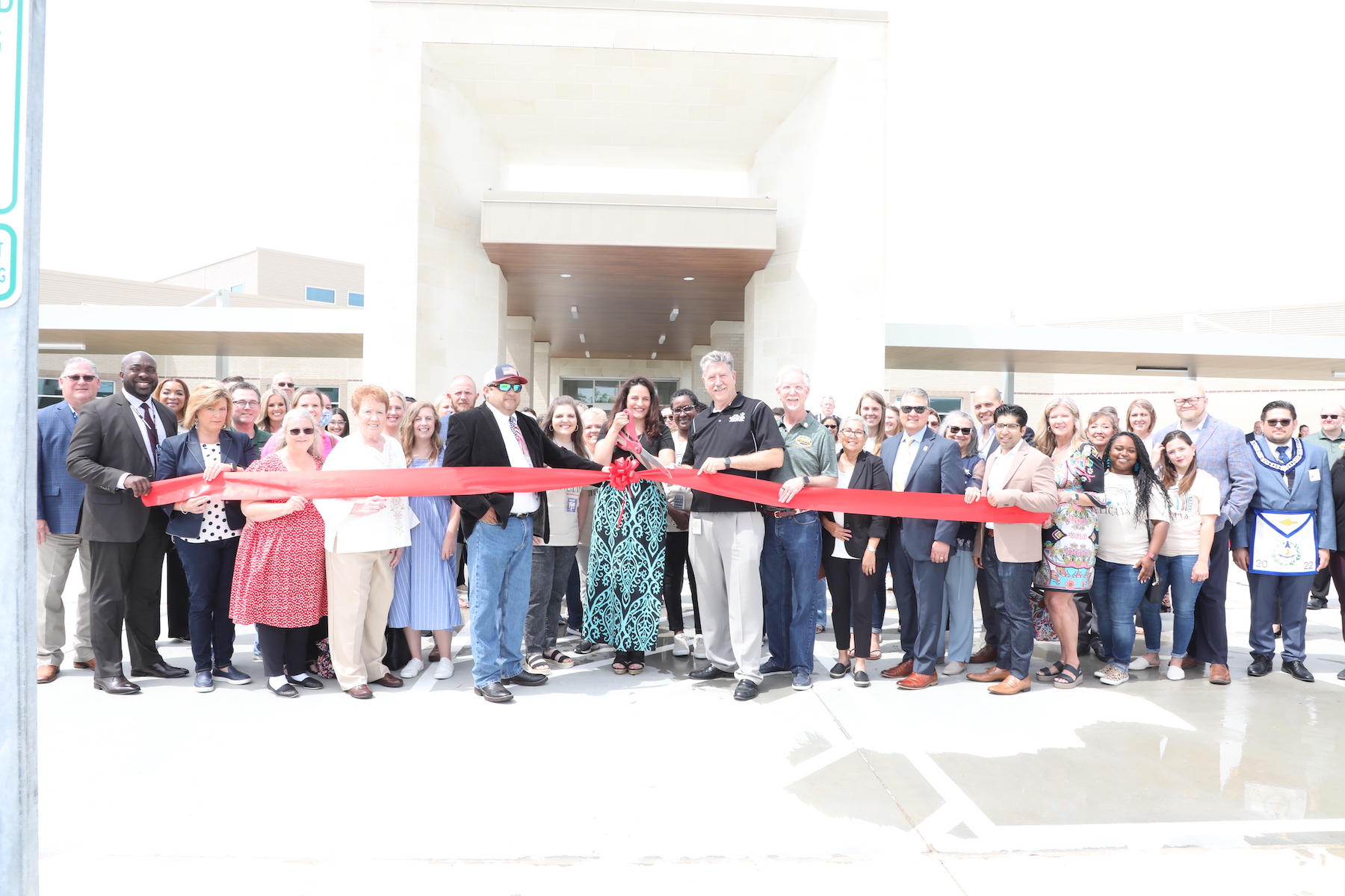 JLP staff, community, and GCCISD admin and board gather together to celebrate the ribbon cutting 