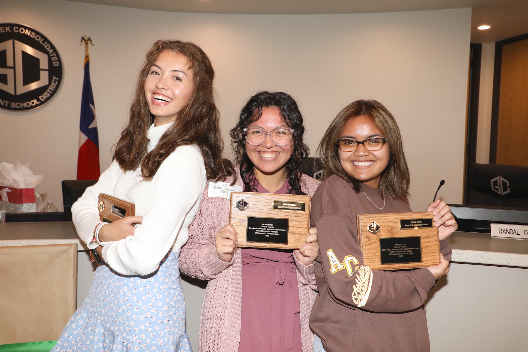 students pose with their award plaques